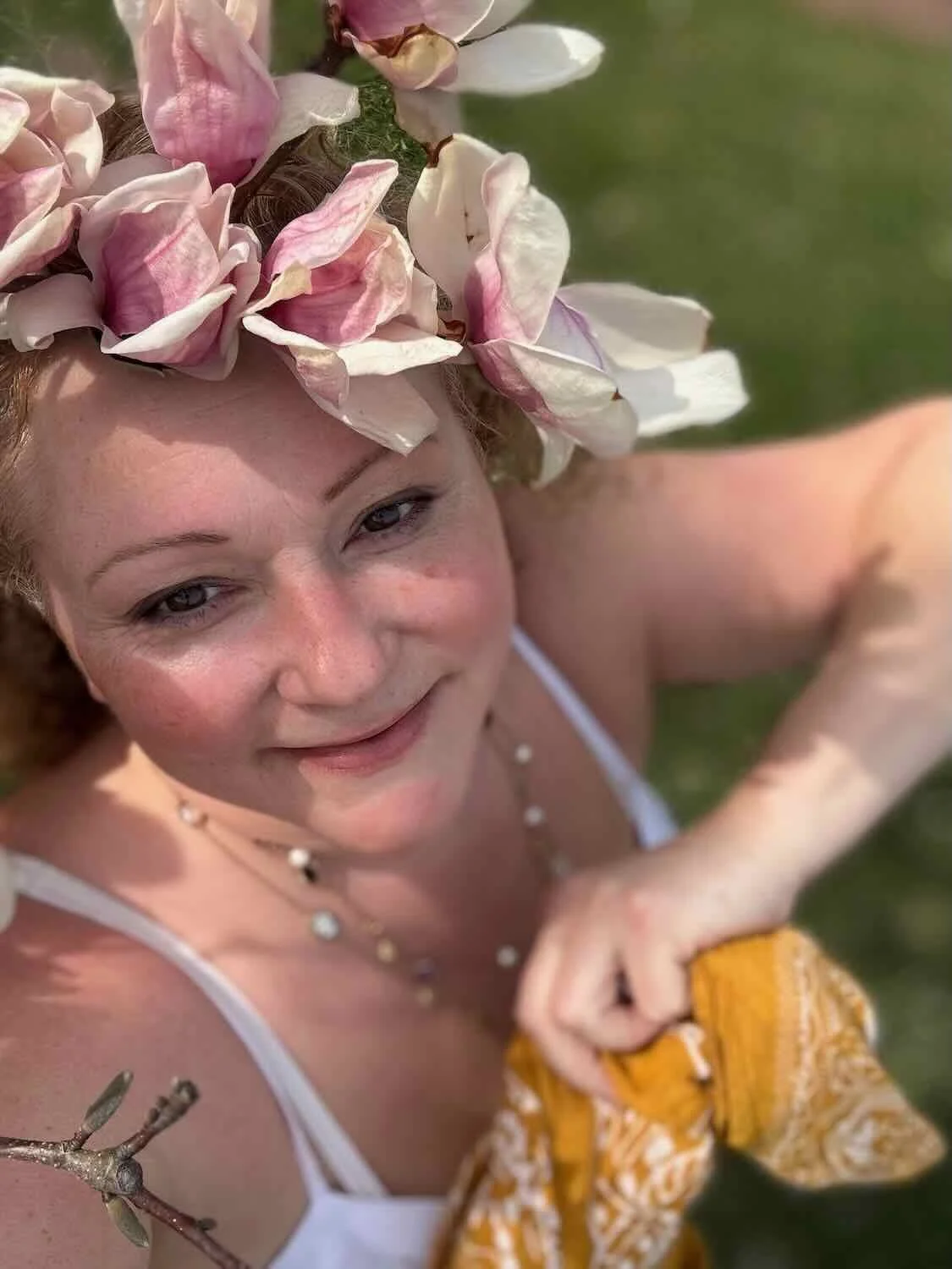 Maya, somatic practitioner and founder of Sacred Love Medicine, photographed outdoors in nature