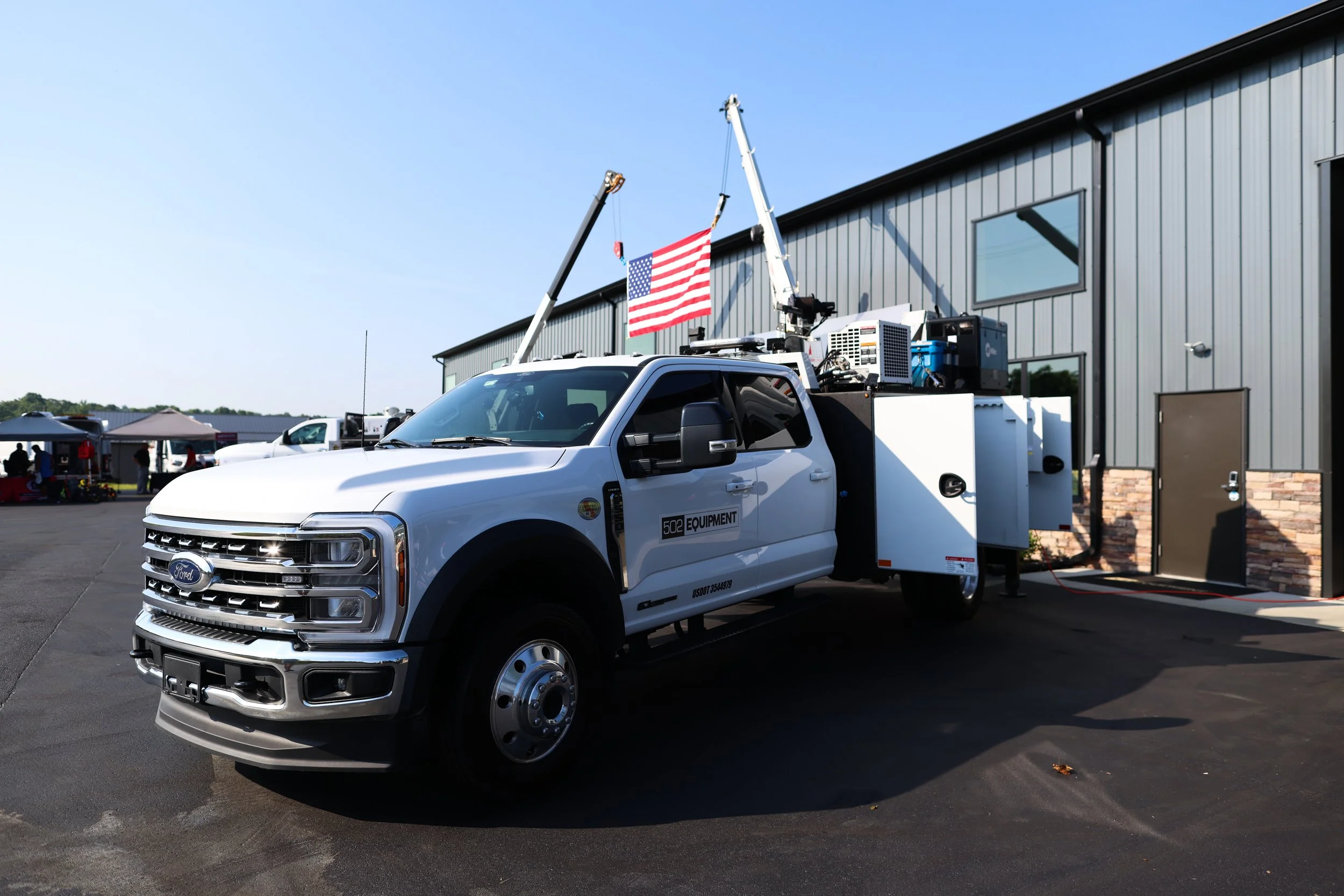 White 502 equipment mobile service truck parked outside the 502 equipment service center near Louisville, Kentucky on a sunny day.