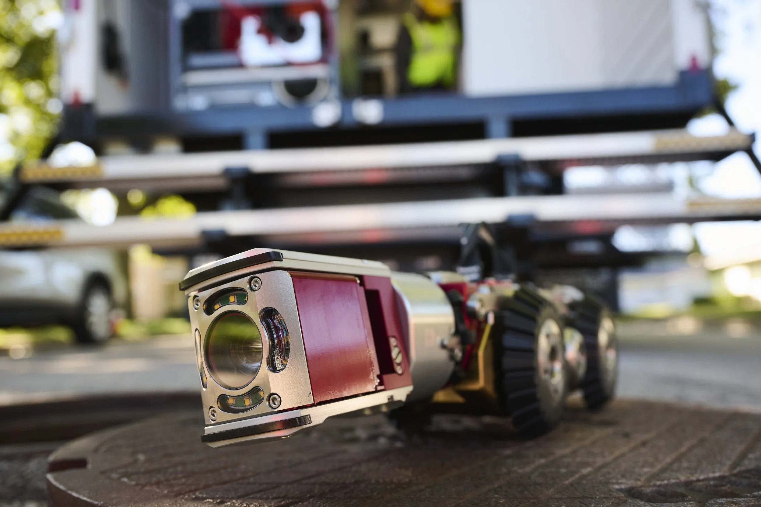 Close-up of an Aries Voyager mainline inspection system with a box truck in the background.