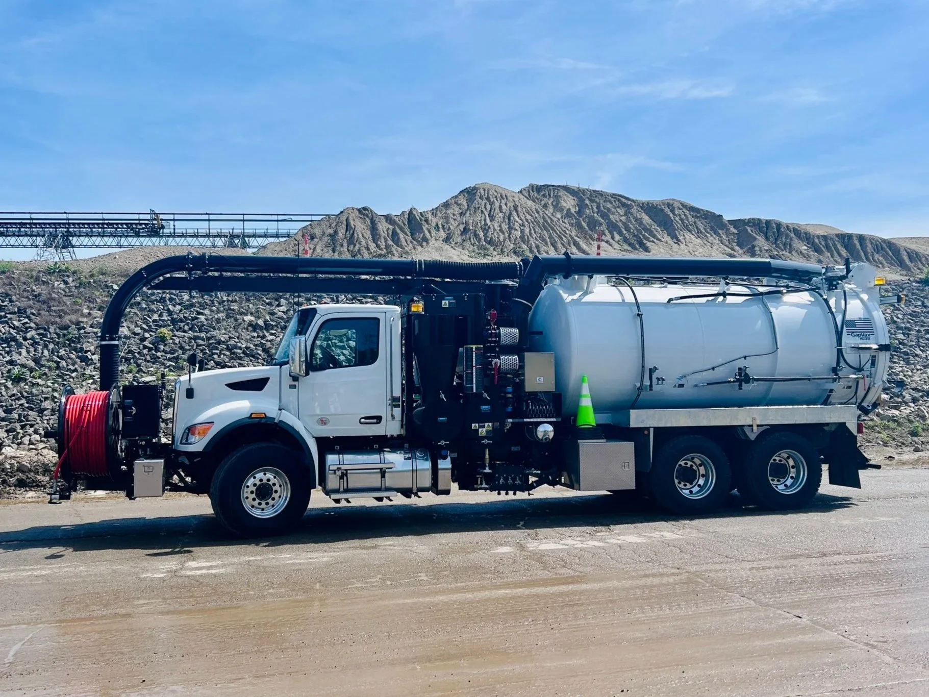 A white GapVax VHE vacuum truck sold by 502 Equipment parked at a gravel manufacturing plant in Louisville, KY.