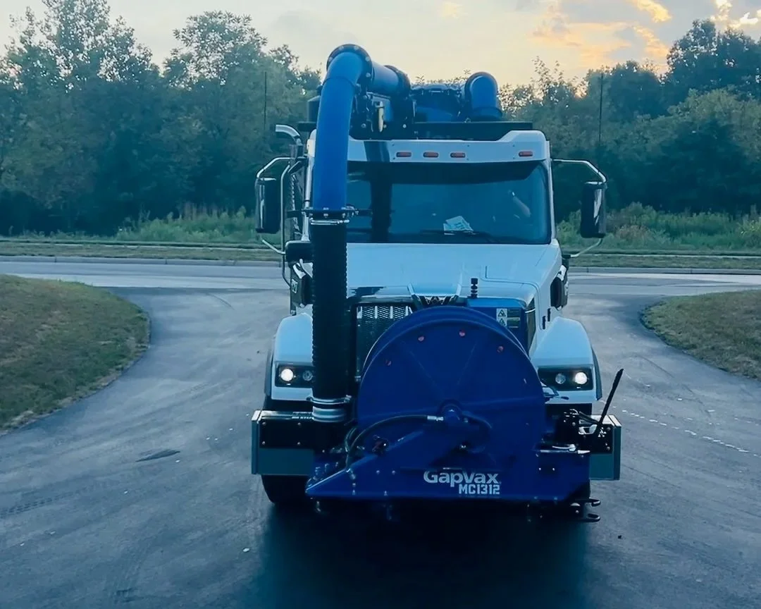 Front view of a GapVax MC vac truck with blue hose reel pulling into the 502 Equipment Service Center near Louisville, KY.