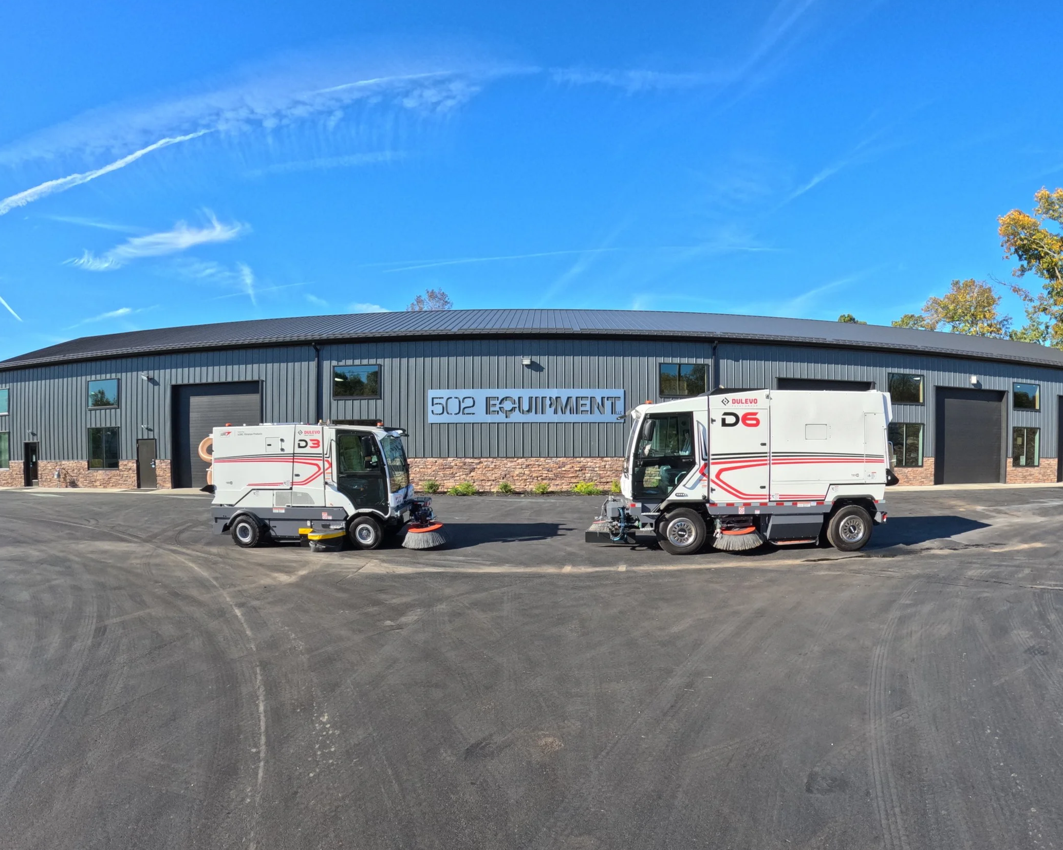 Two street sweepers parked outside the 502 Equipment Street Sweeper Service Center in LaGrange, KY.