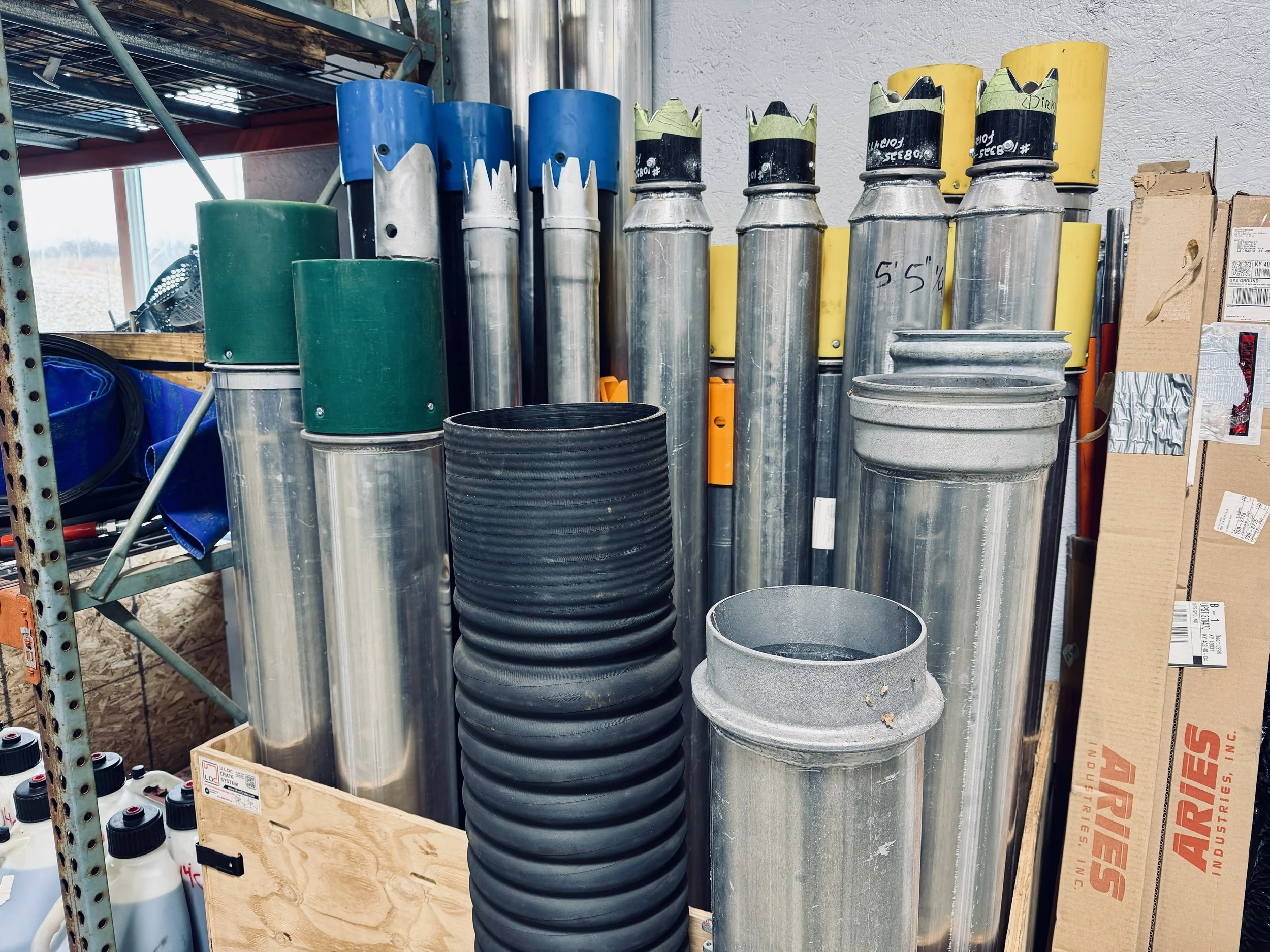 Vacuum truck accessories like dig tubes and boom tubes of all sizes standing in a storage crate at the 502 Equipment service center in LaGrange, KY.
