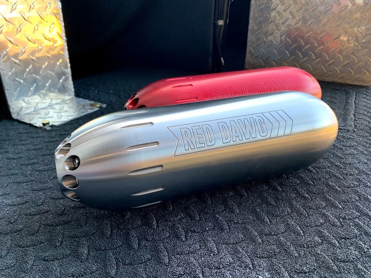 Red Dawg big texan nozzles, one silver and the other red on a metal surface. 