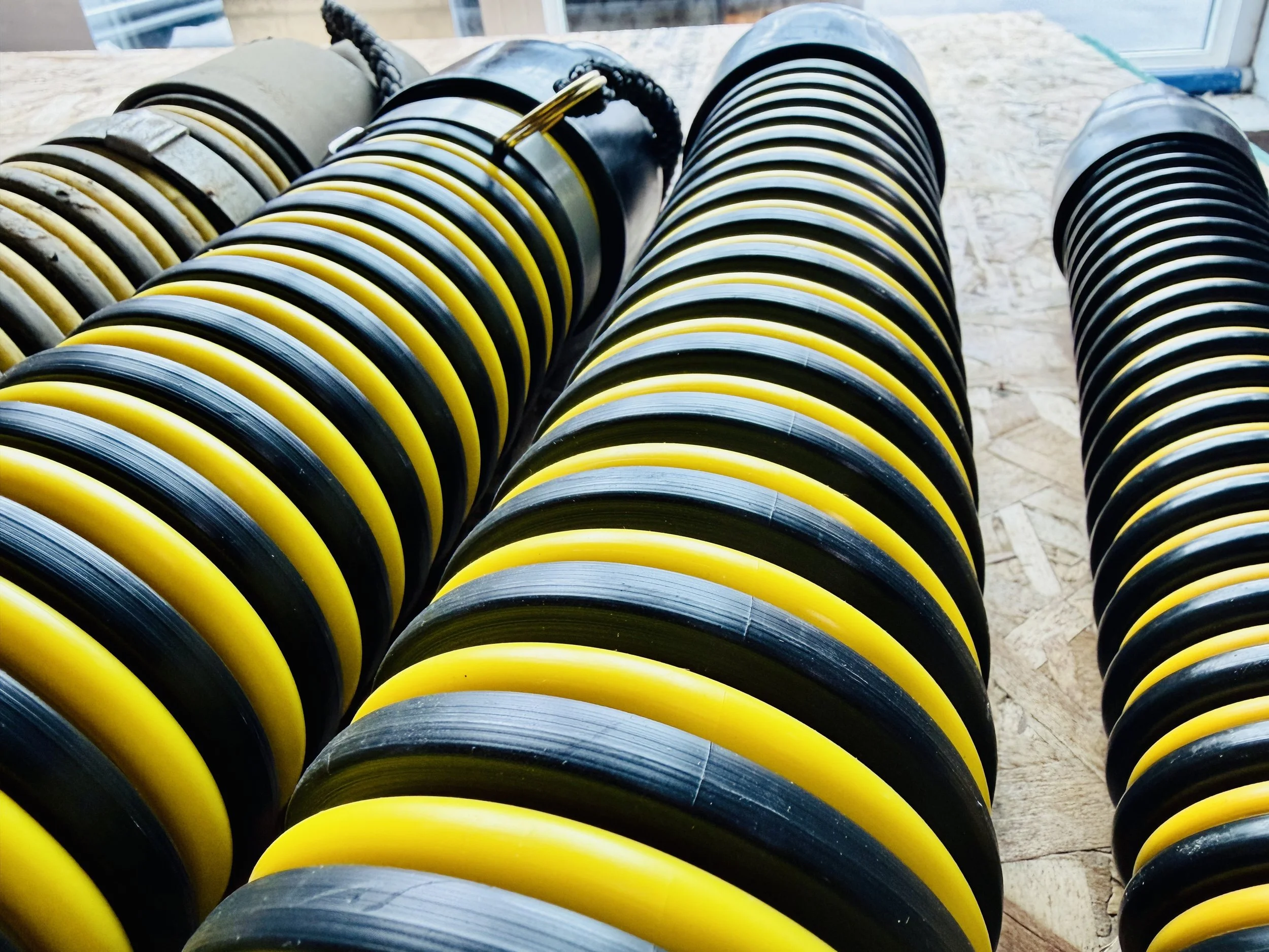 Close-up of black and white striped tiger tail hoses available for sale by 502 Equipment in LaGrange, Kentucky in Oldham county.