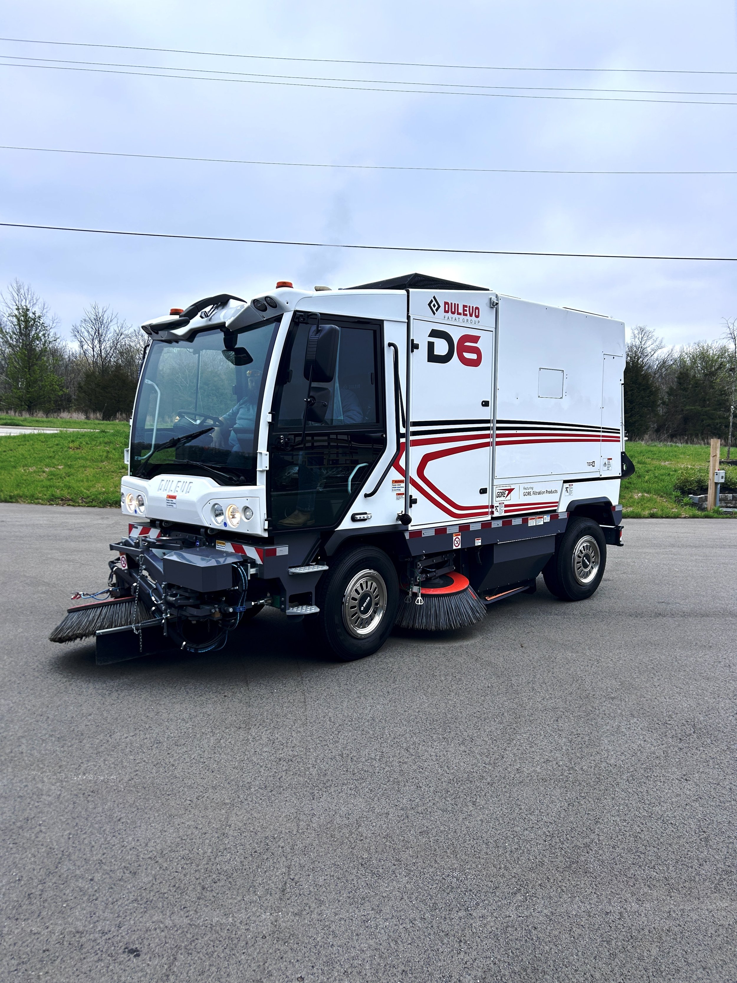 A dulevo sweeper with a white body, red and black accents, sold by 502 Equipment parked the 502 Equipment Service Center in LaGrange, KY.