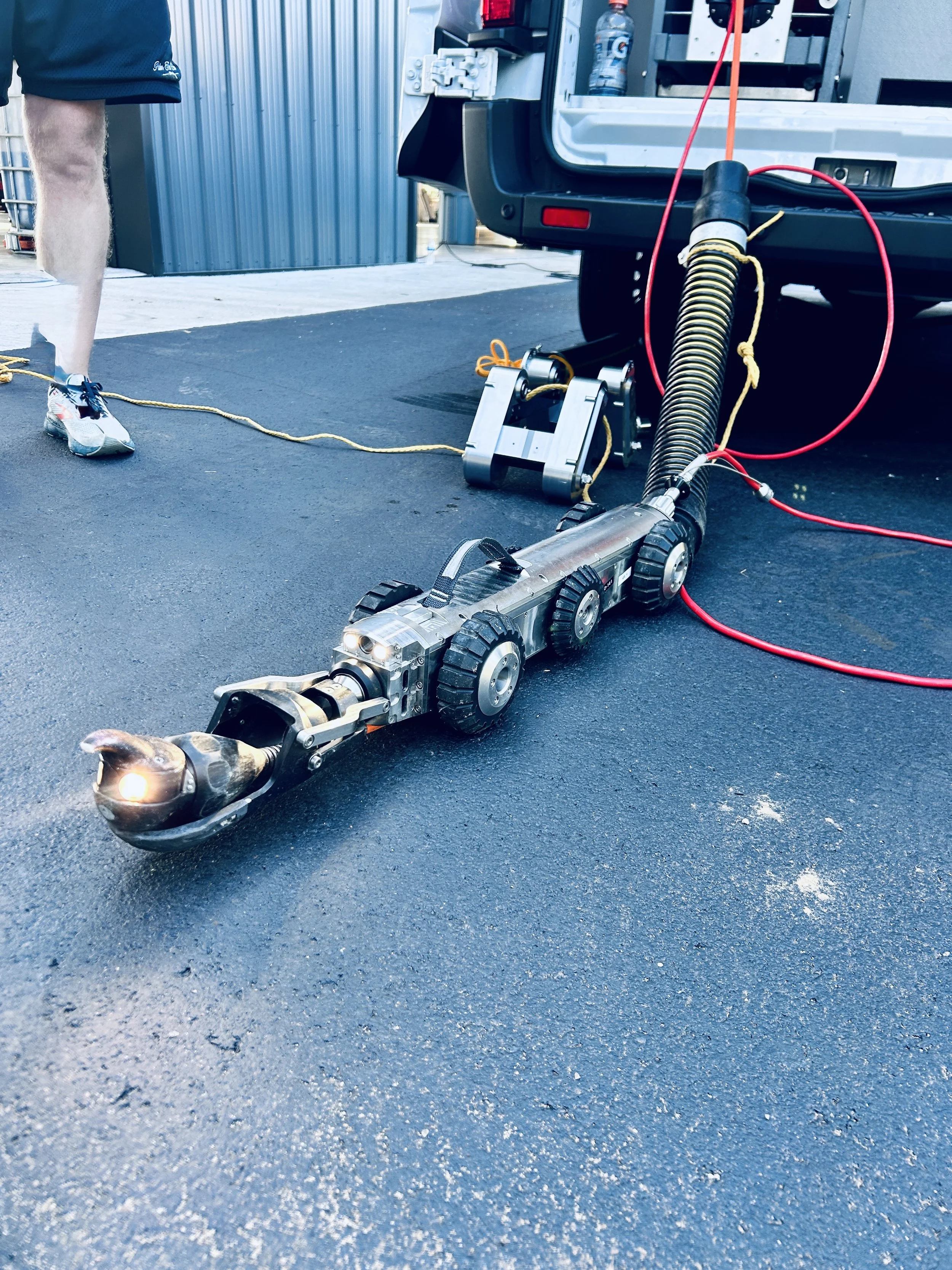 The Aries LETS lateral launch camera system is a robot on wheels with a camera and a light staged on concrete for its next inspection near Columbus, Indiana.