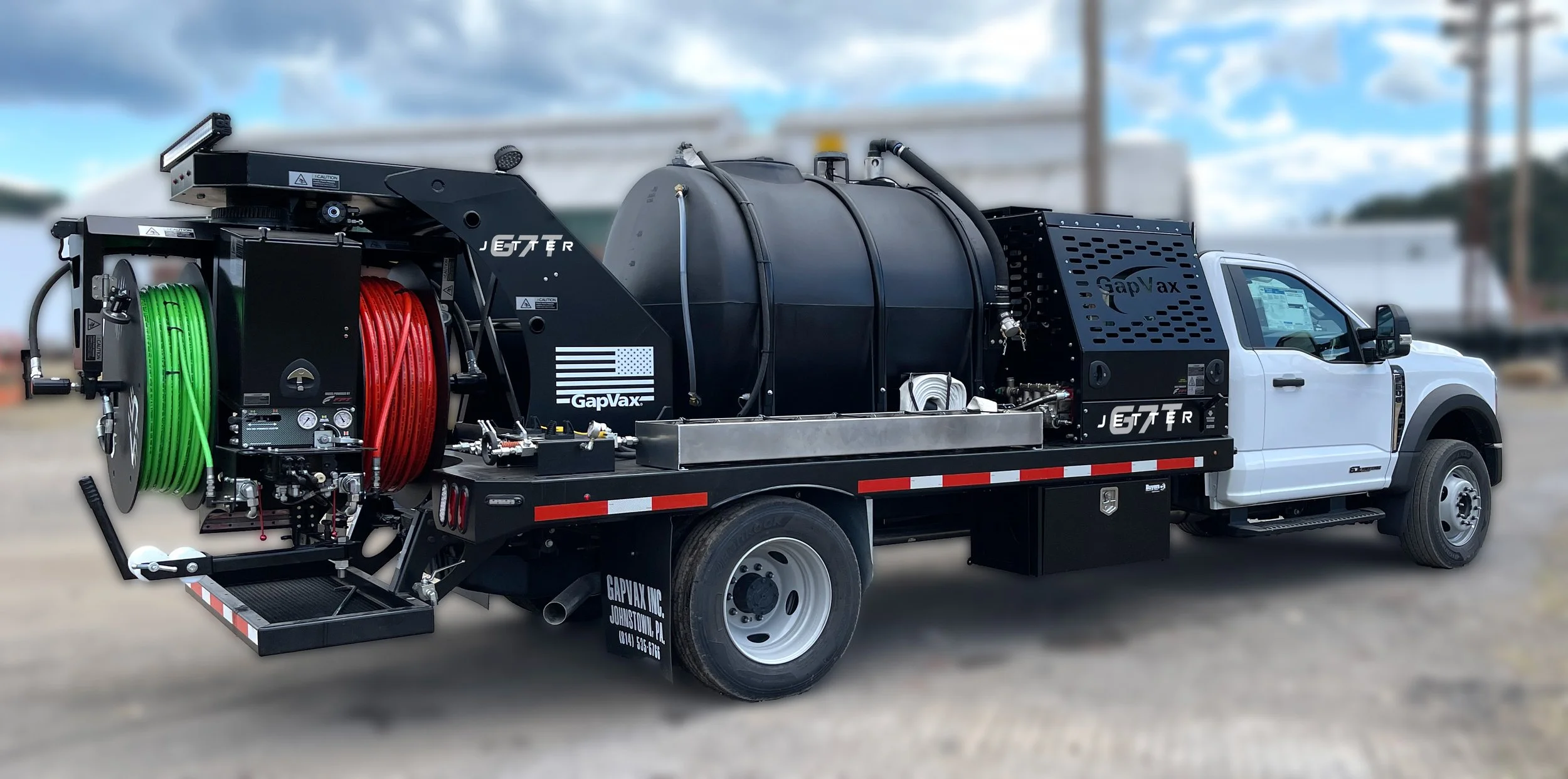 The gapvax g7t, a powerful truck mounted jetter with 2 sizes of hose reels is parked in a gravel lot near Nashville, TN