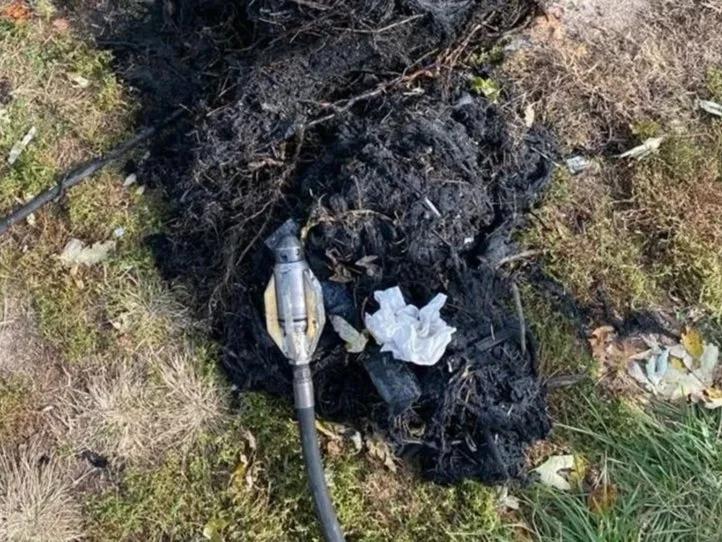 Roots and other debris pulled from sewer lines with a hose and a warthog sewer nozzle on the ground outdoors.