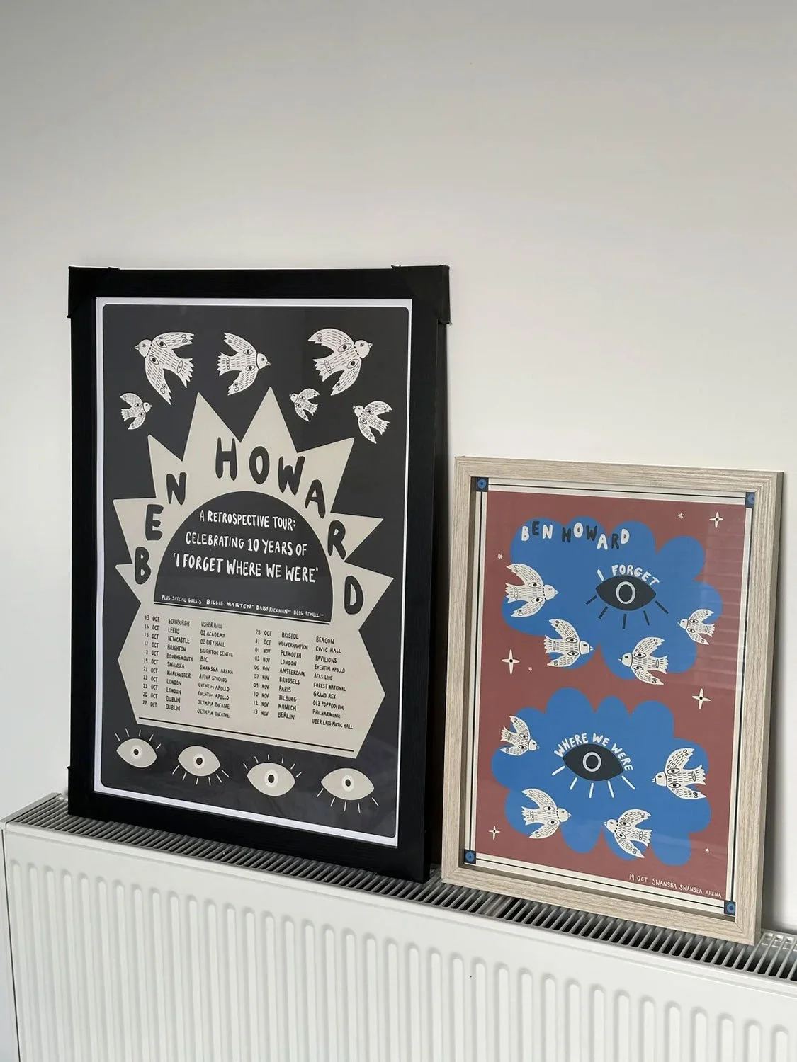 Two posters celebrating Ben Howard's music tour. The black poster on the left lists tour dates, while the other features flying birds around eye symbols with the words 'Ben Howard' and 'Where We Were'.