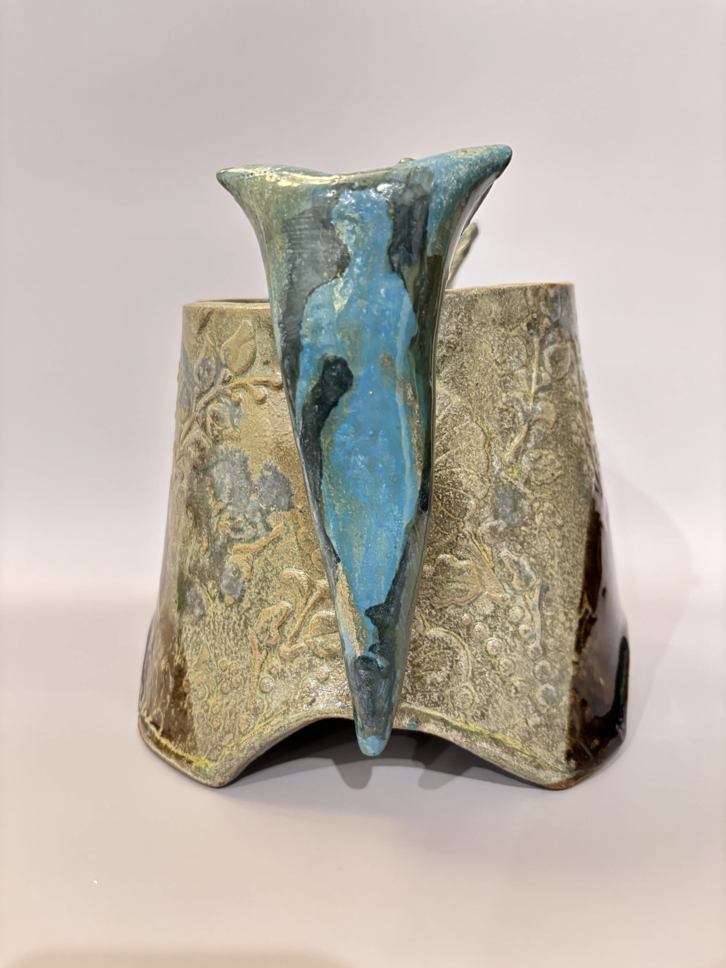 textured vase with silhouette on handle