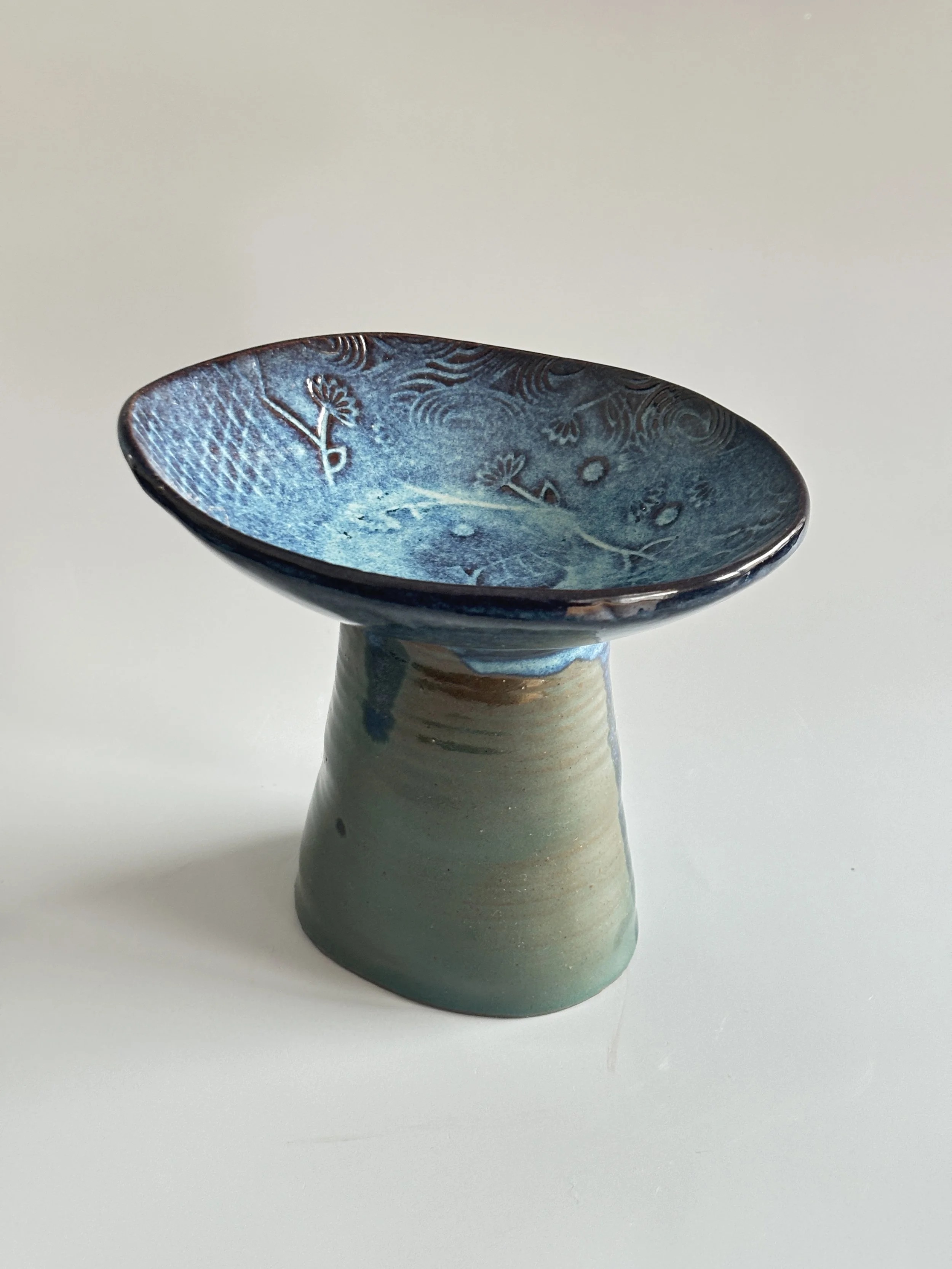 textured bowl atop thrown cylendar
