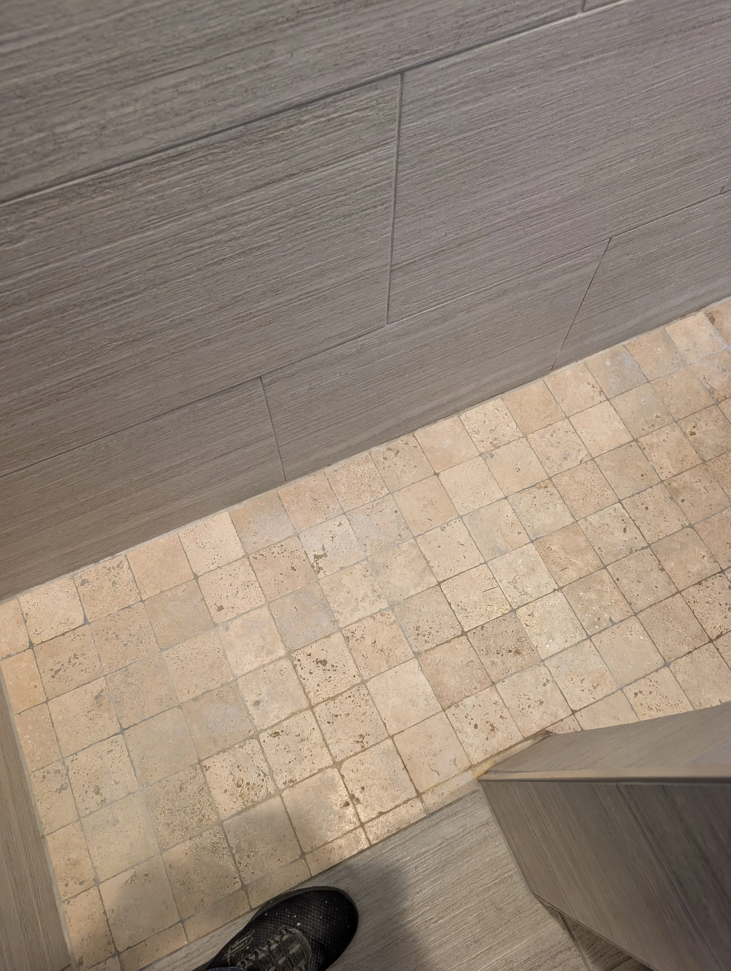 Dated shower threshold with cracked grout before professional tile replacement in Flower Mound, TX. 5C Home Solutions handles full shower floor retiling in Denton County.