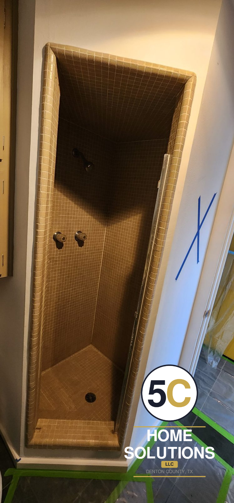 Before: narrow 1960s tan mosaic tile shower stall with dated fixtures, Denton County TX
