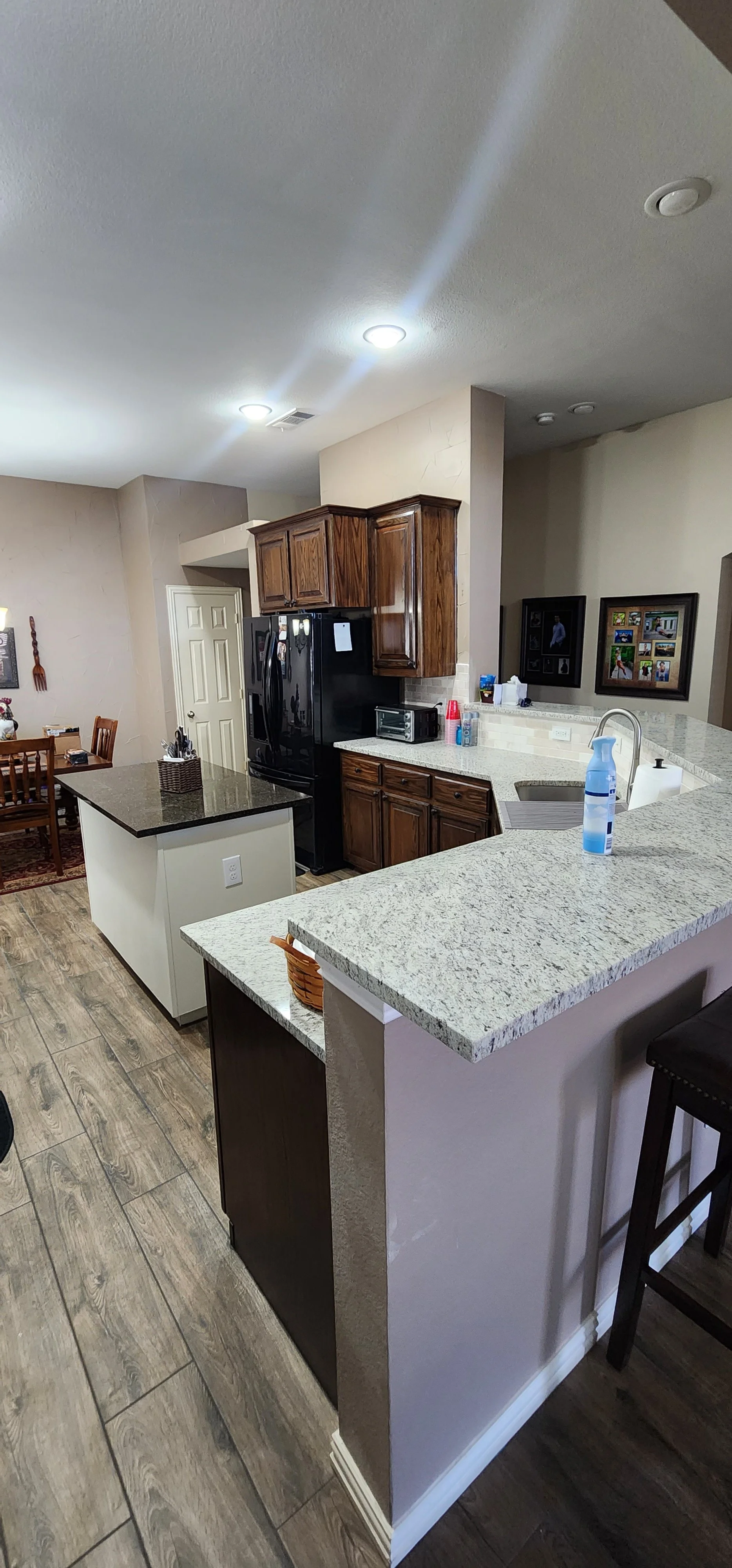 Re-stained cabinets and new granite countertops in this Lantana kitchen renovation.