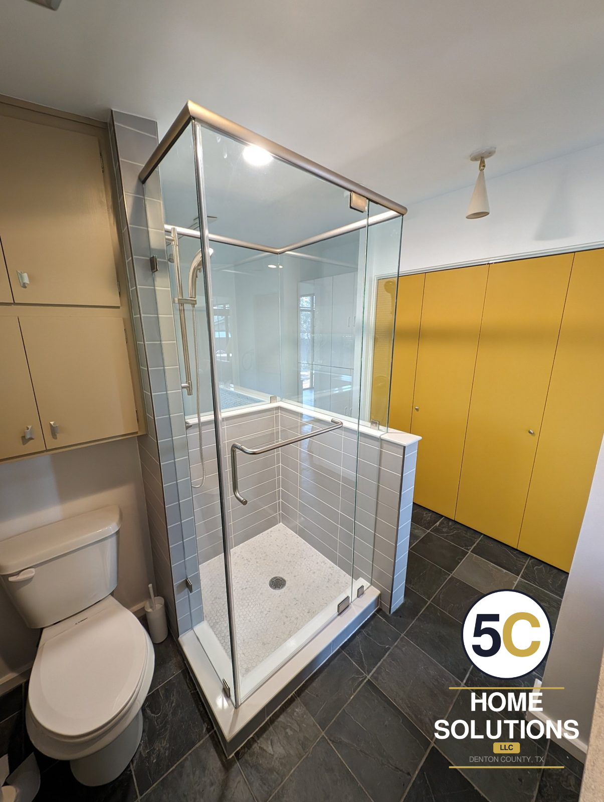 After: walk-in shower with glass enclosure, gray tile walls and white penny tile floor by 5C Home Solutions, Denton County TX
