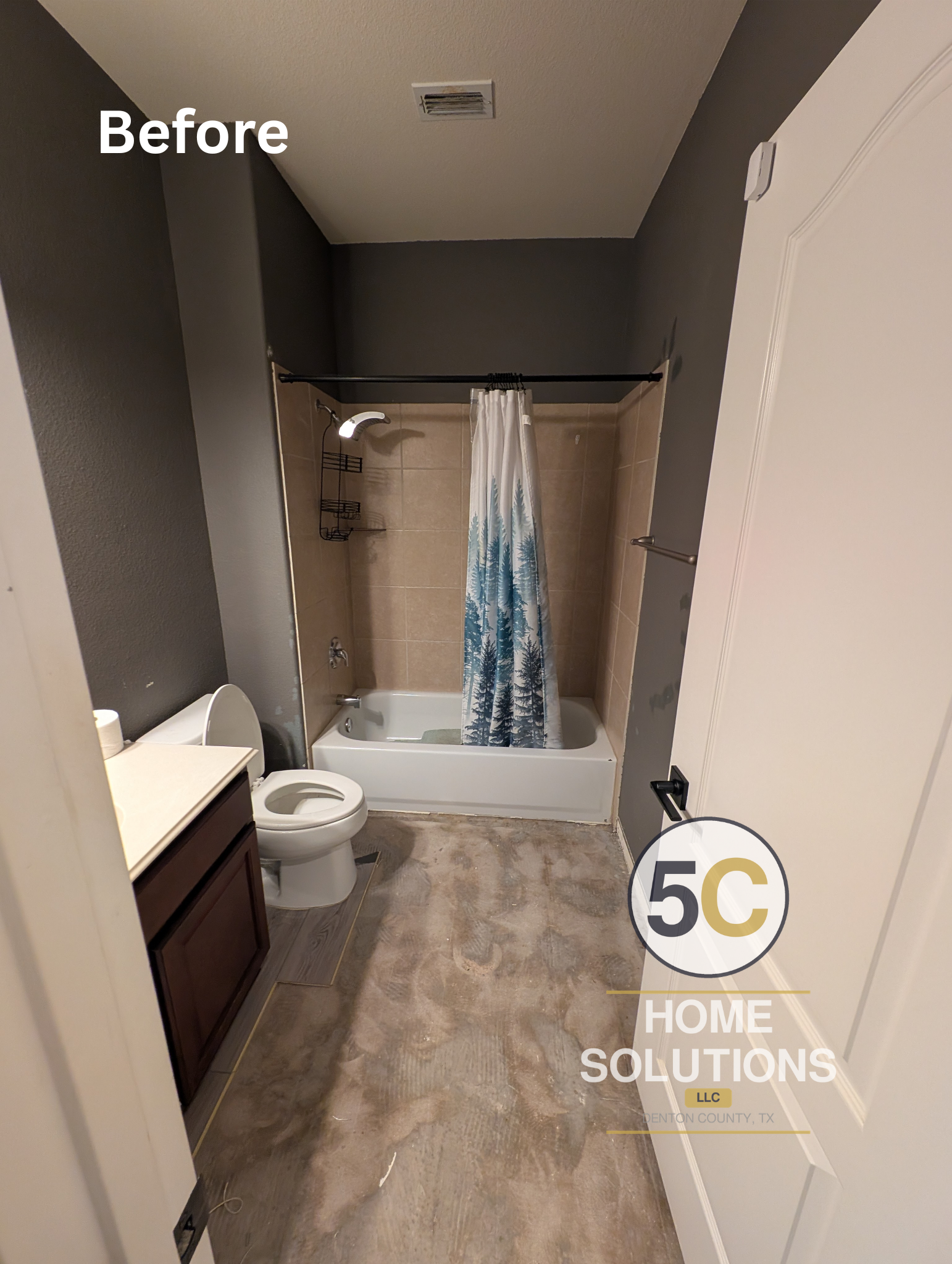 Before photo showing the original guest bathroom mid-demo, with dated tan tile shower surround, exposed subfloor, and old vanity — prior to the full renovation in Lake Dallas, TX.