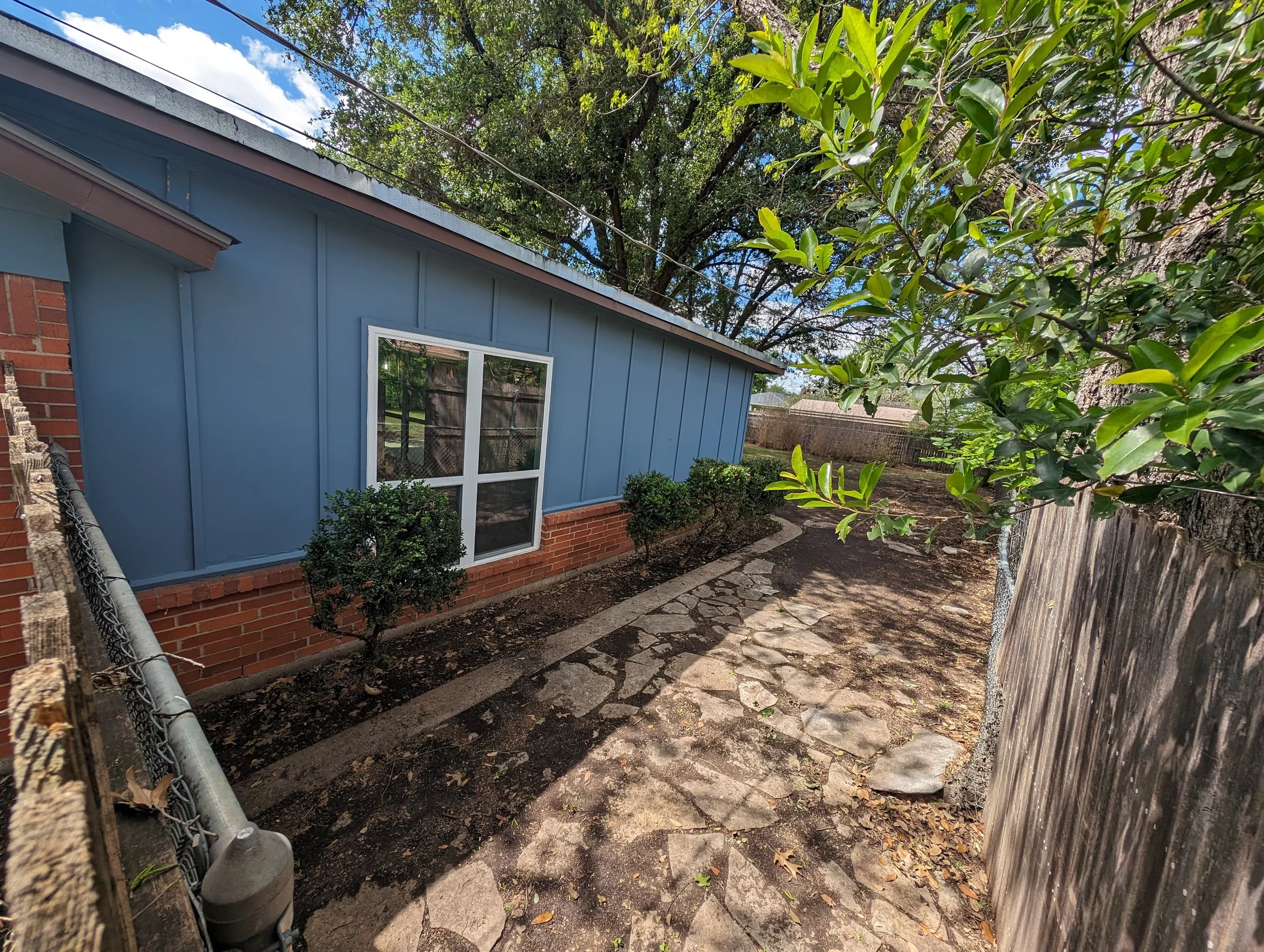 Back wall and brick before painting on home in Denton County, TX