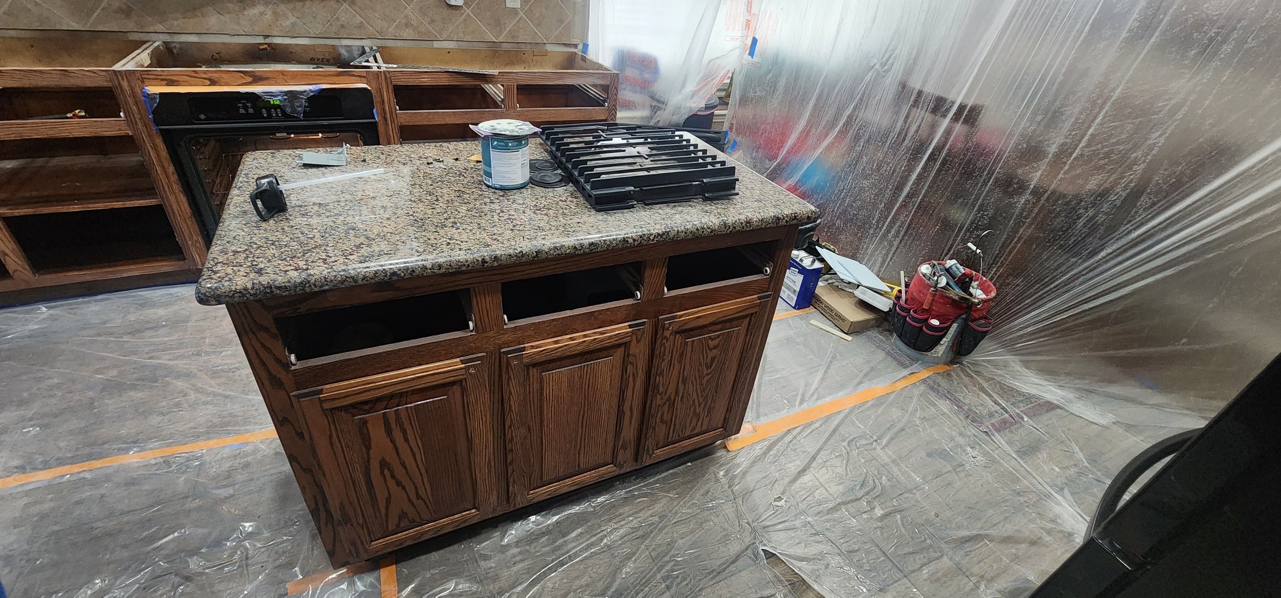 Re-stained cabinets and new granite countertops in this Lantana kitchen renovation.