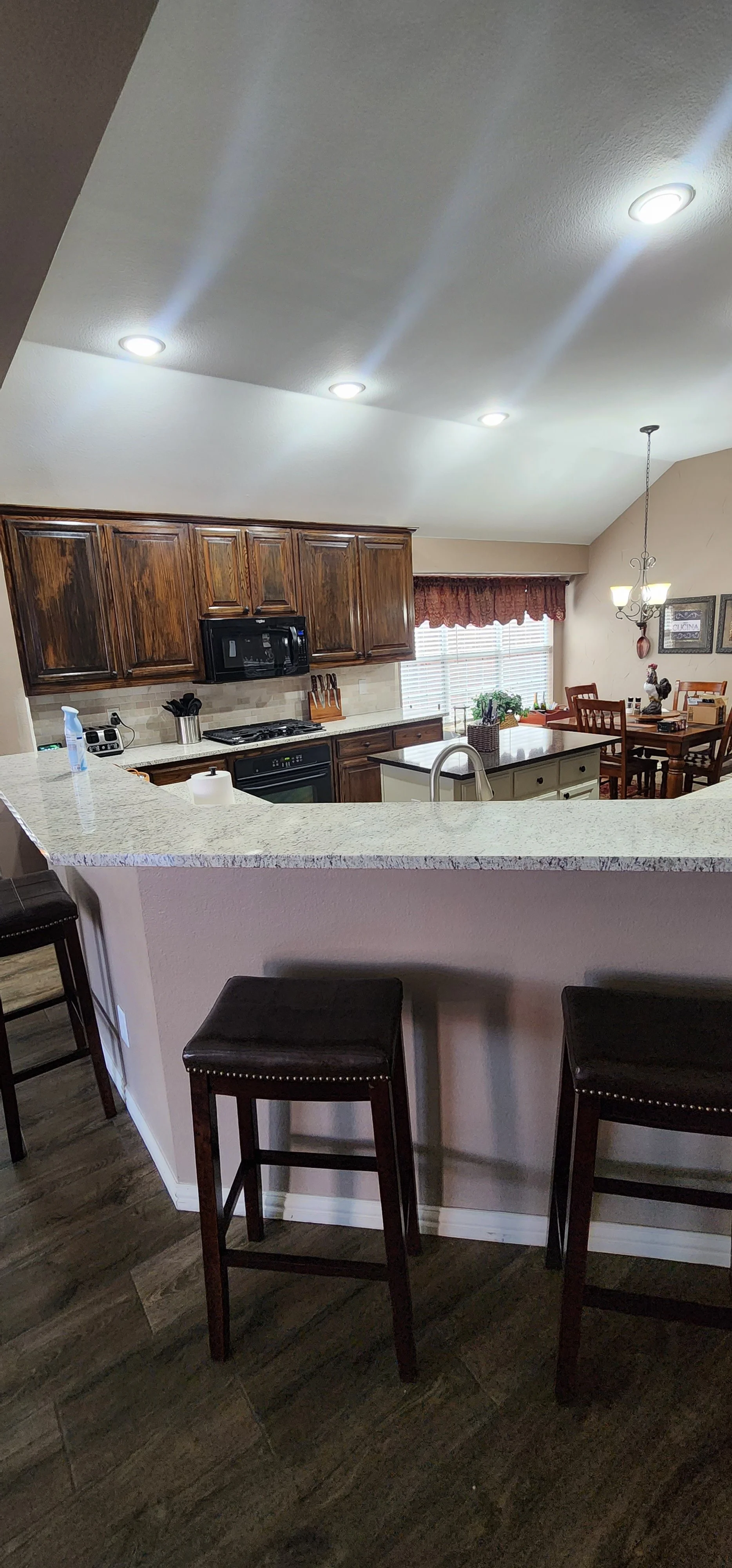 Re-stained cabinets and new granite countertops in this Lantana kitchen renovation.