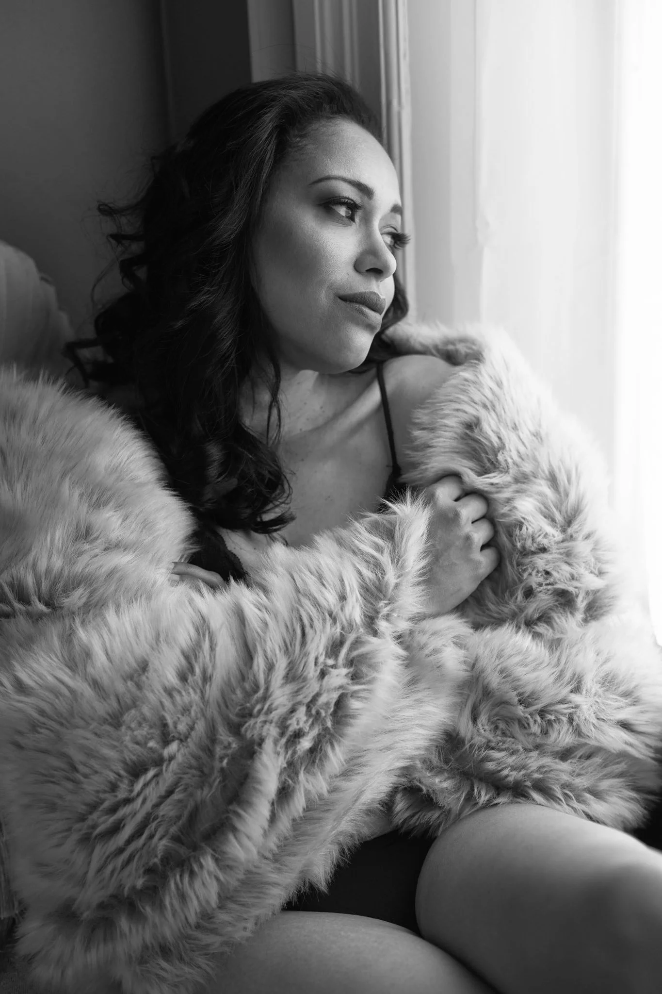 "Black & white boudoir image woman in window light wrapped in shawl" 