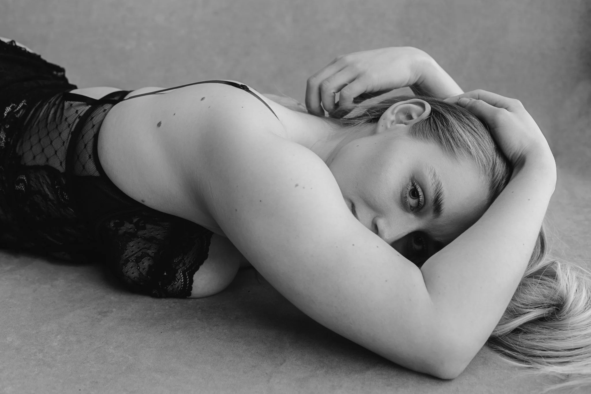 "Emotional expression during luxury boudoir photography session"