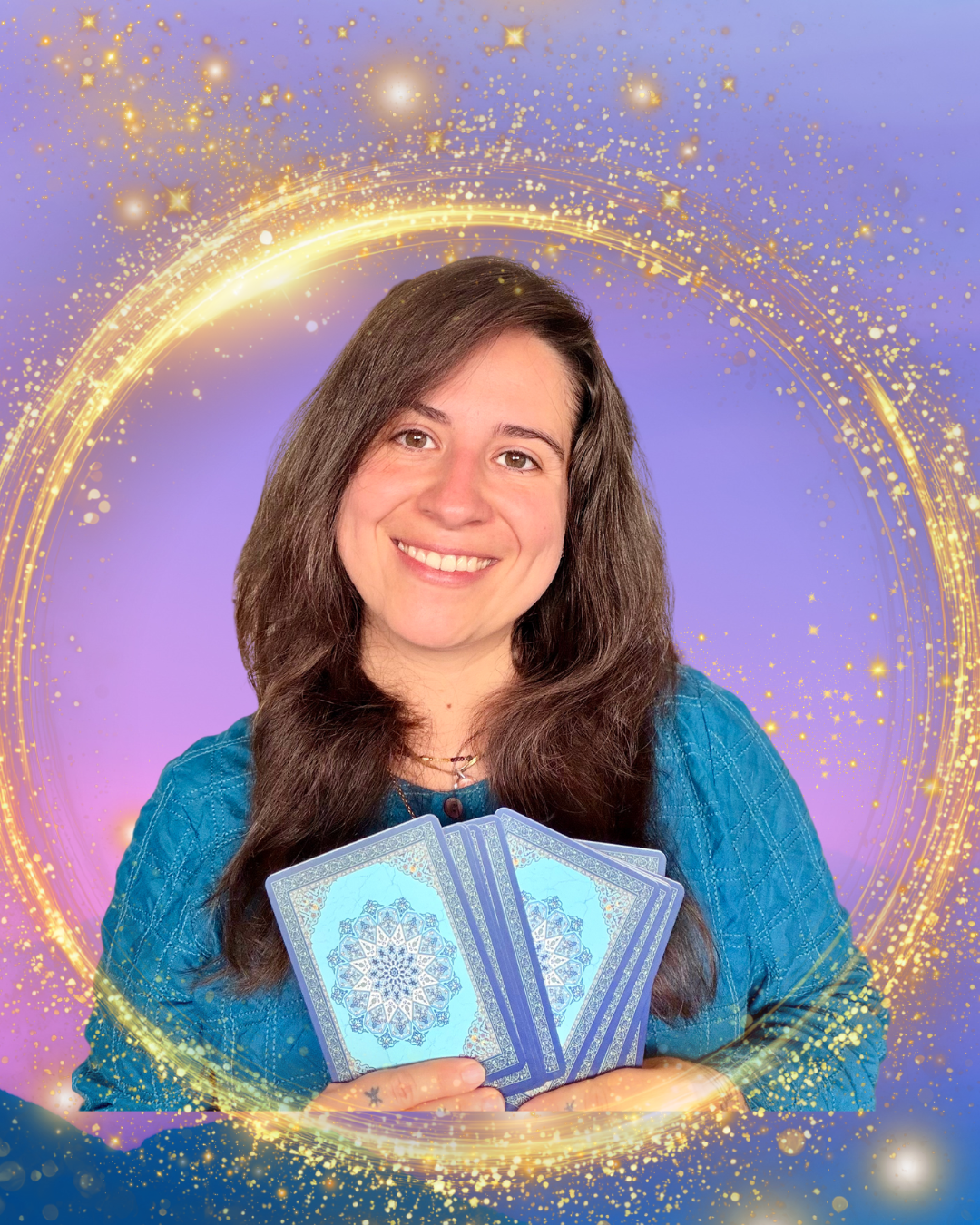 A woman with long dark brown hair, smiling, holding blue tarot cards with intricate designs, standing in front of a mystical purple background with gold sparkles and circular patterns.