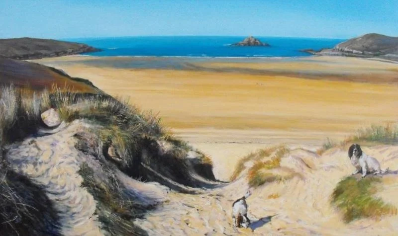 A landscape depicting sandy dunes leading to a grassy marsh, with a large body of water and a rocky island in the distance under a blue sky.