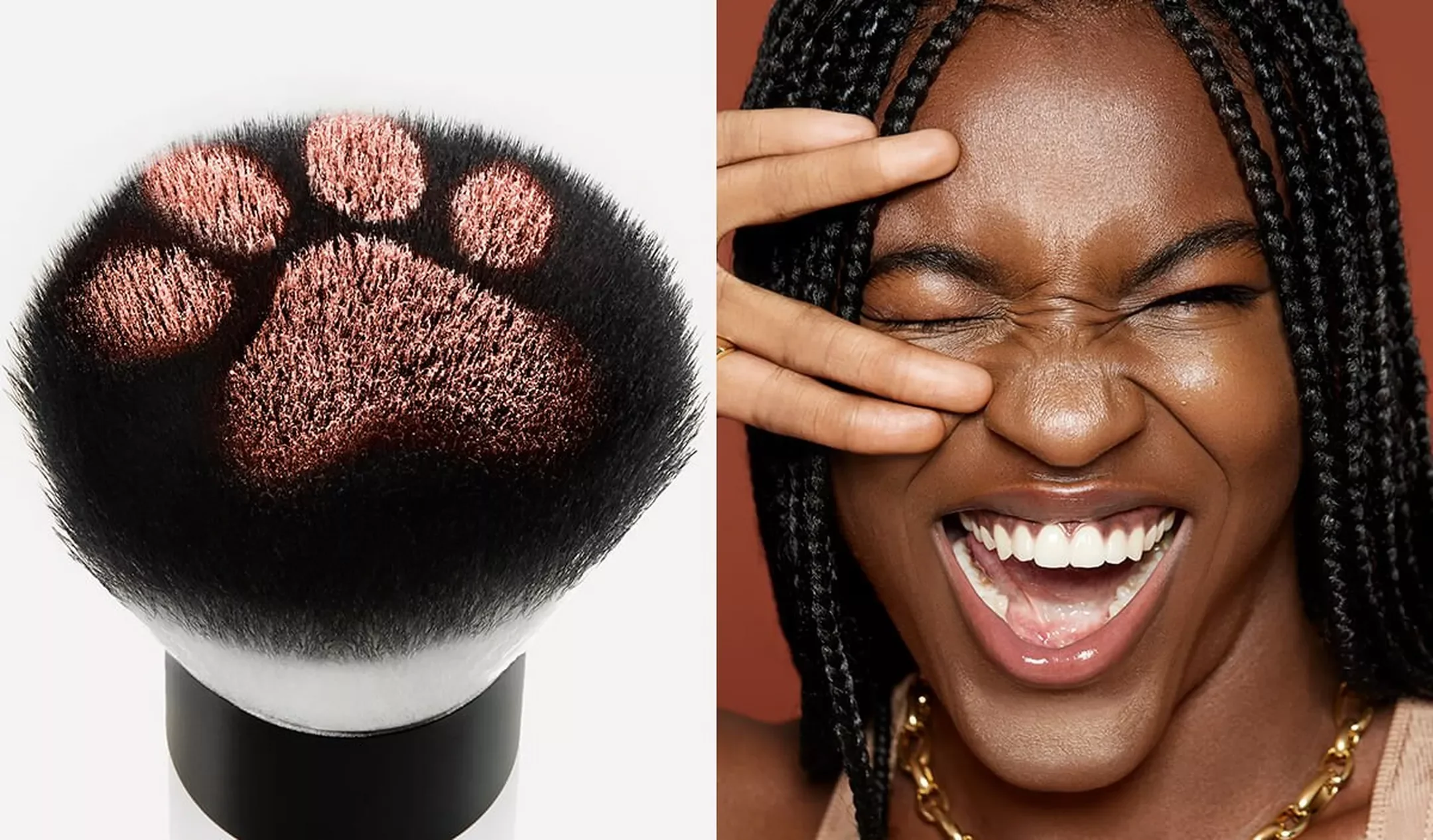 A makeup brush with black bristles and pinkish-beige eyeshadow makeup on the top of its bristles, next to a smiling woman with dark braided hair, dimples, and closed eyes, making a playful facial expression.