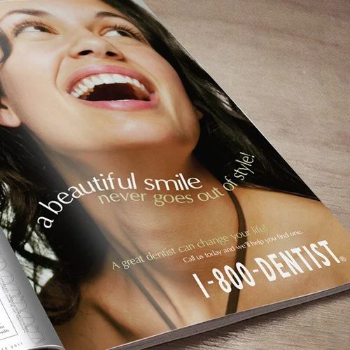 Close-up of a smiling woman with white teeth in a print advertisement for 1-800-DENTIST, highlighting her cheerful expression.