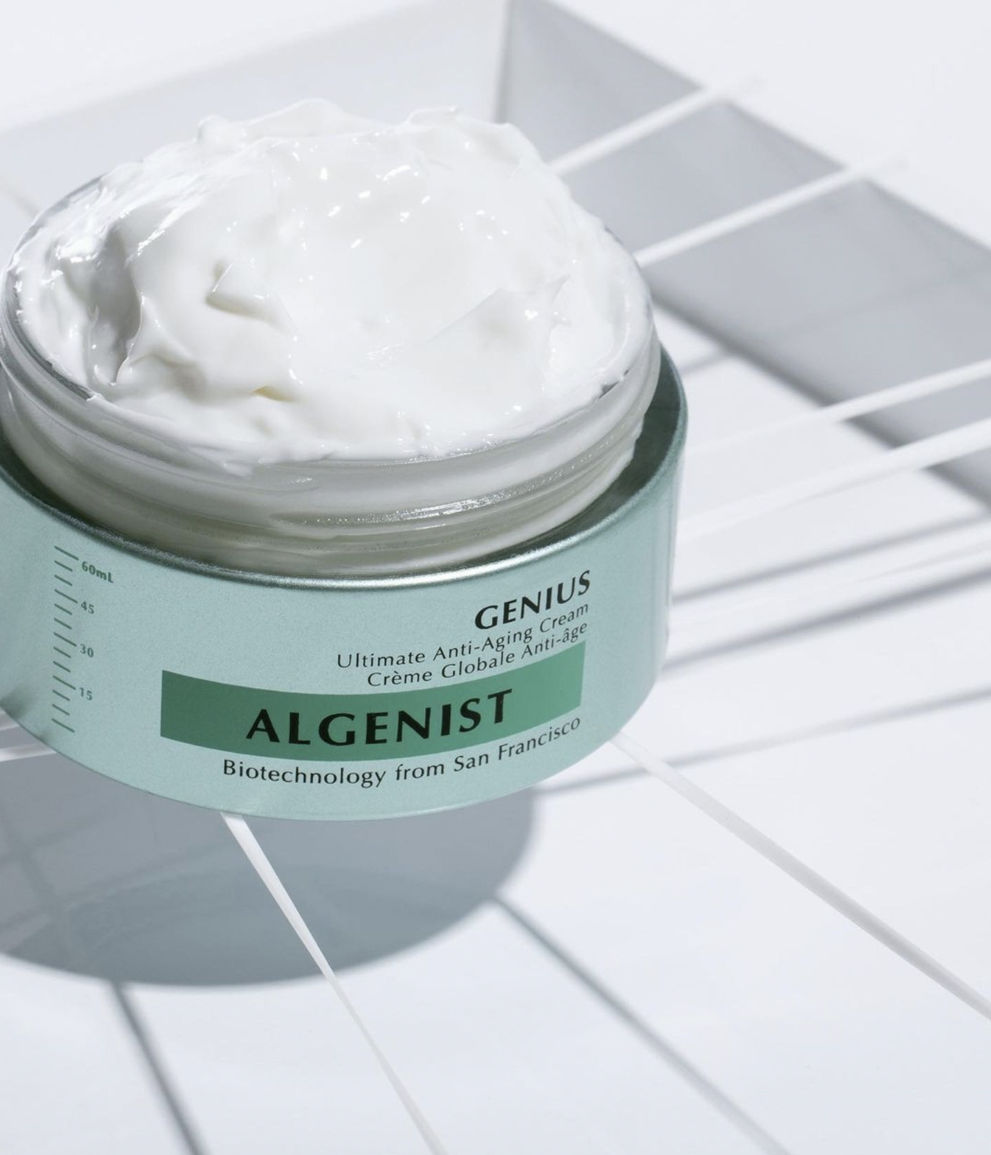 Agenist Genius Anti-Aging Cream shot on white rubber bands to illustrate that the product helps skin elasticity.