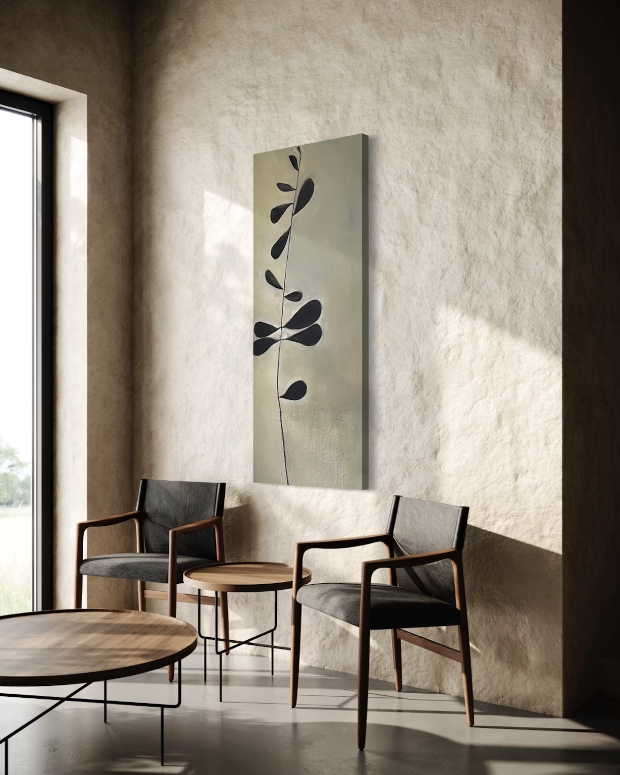Modern interior room with two black and wood armchairs, small round wooden side table, large abstract painting of a black leaf on a beige wall, and a large window letting in natural light.
