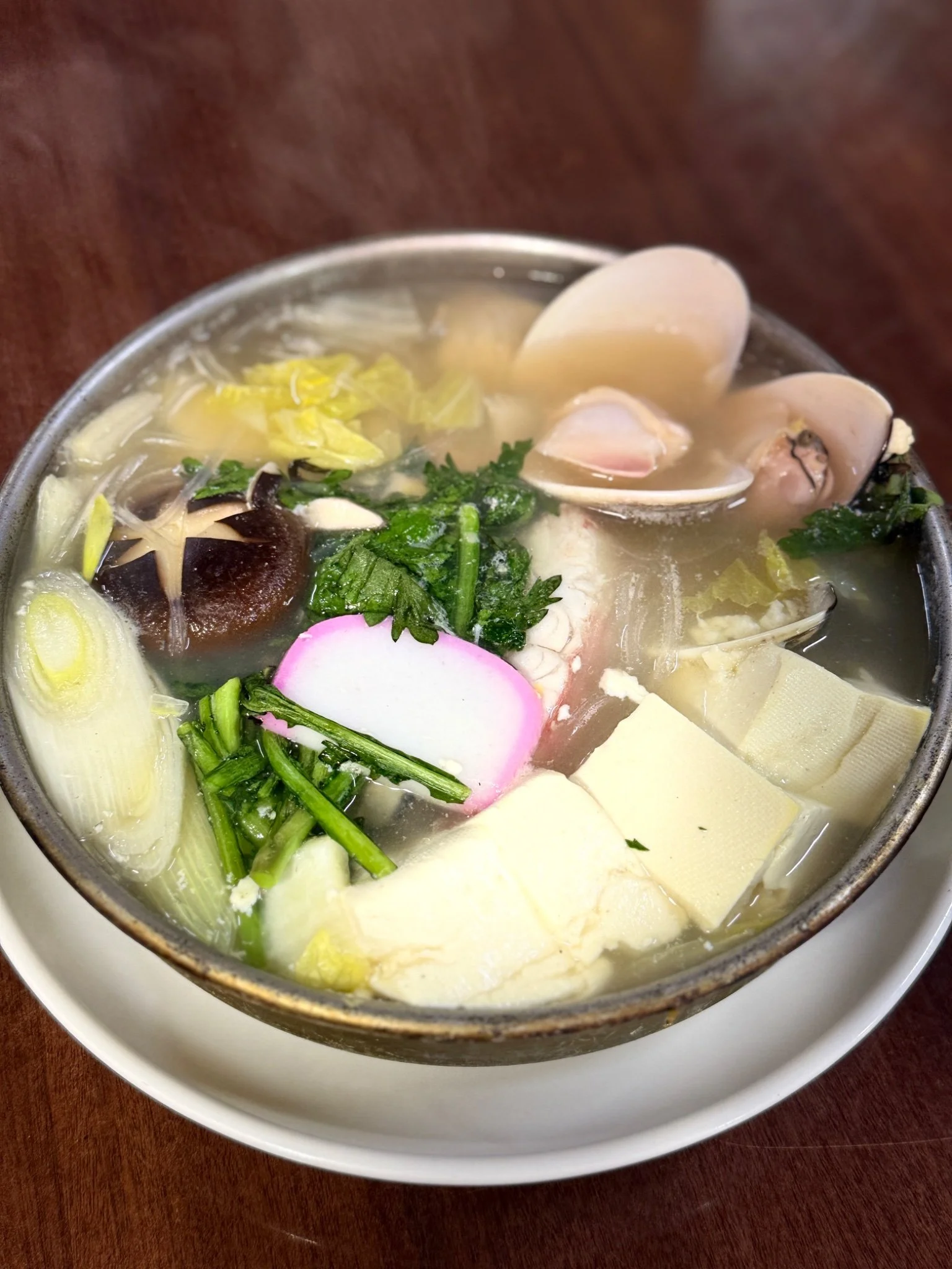 Photo of a hearty soup packed with hot vegetables and shellfish