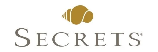 Logo with a gold seashell above the word 'SECRETS' in gray text.