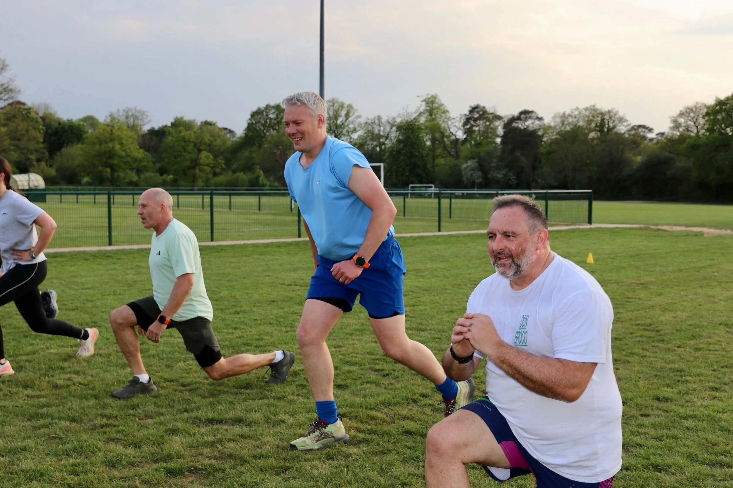 Group of male group exercise attendees working hard.