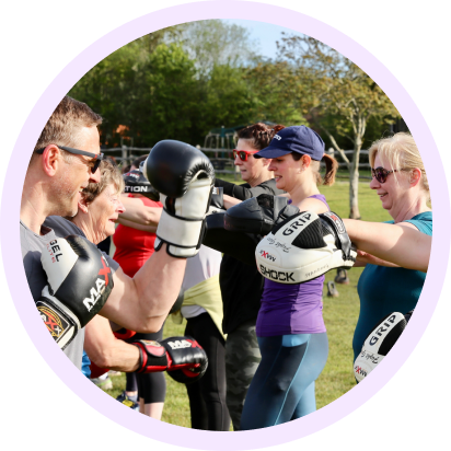 Outdoor exercise group boxing together.