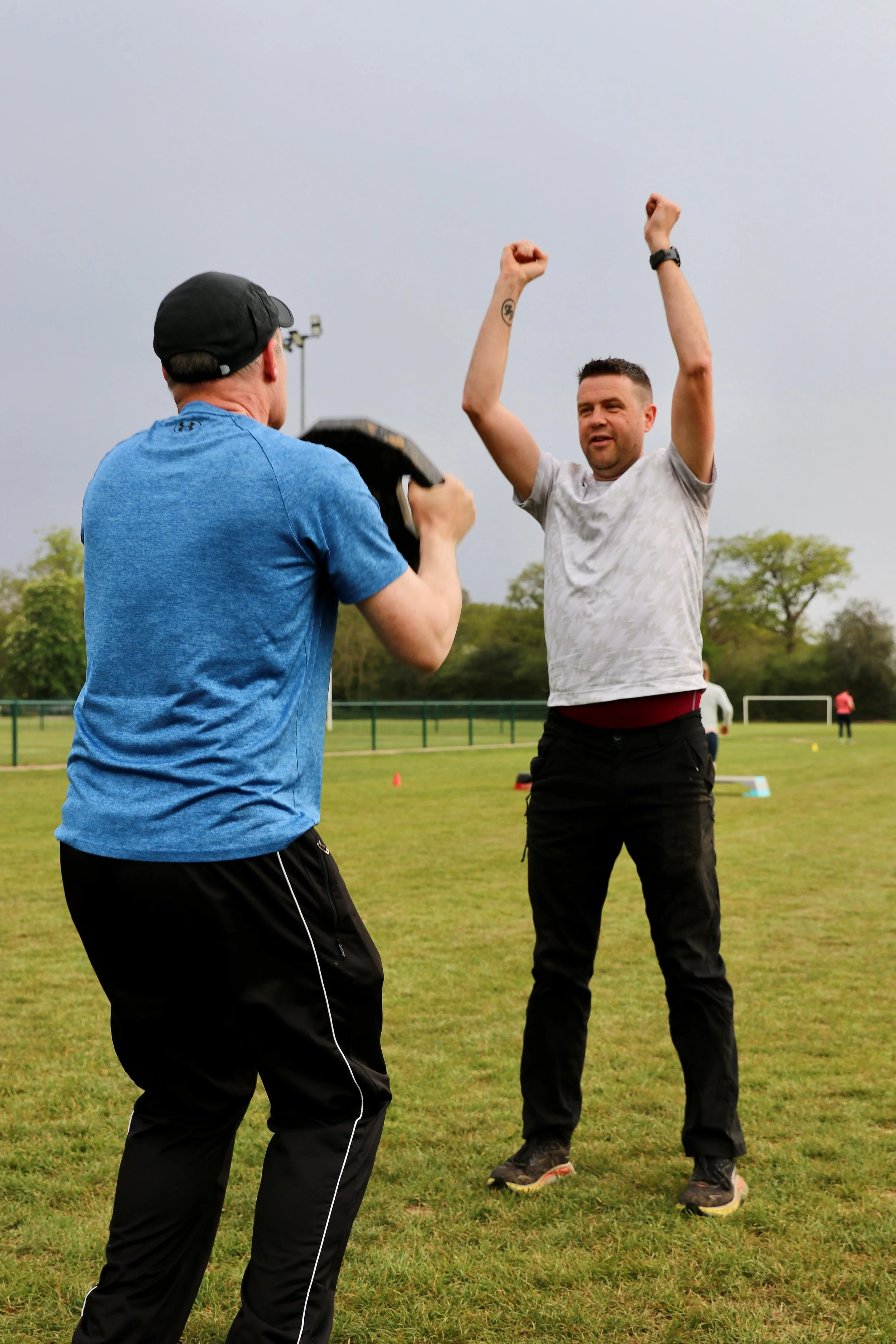 Personal trainer working with a client.
