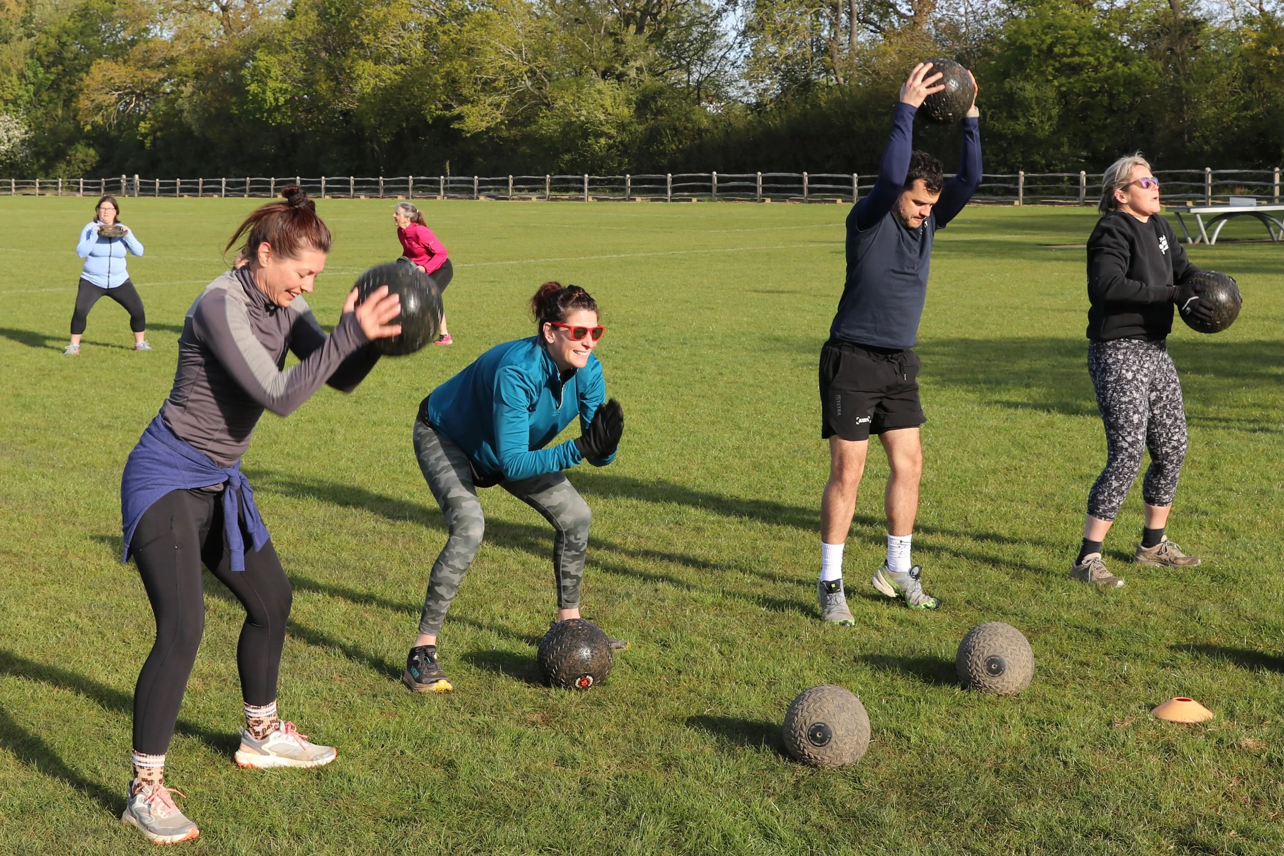People lifting weights at a group exercise session.
