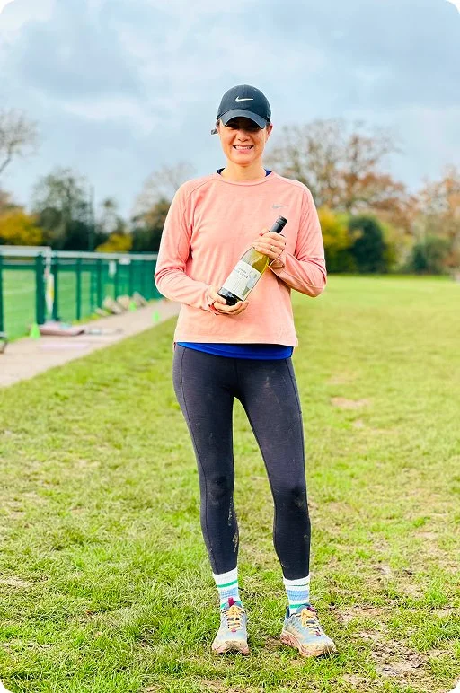 Female holding a bottle of wine.