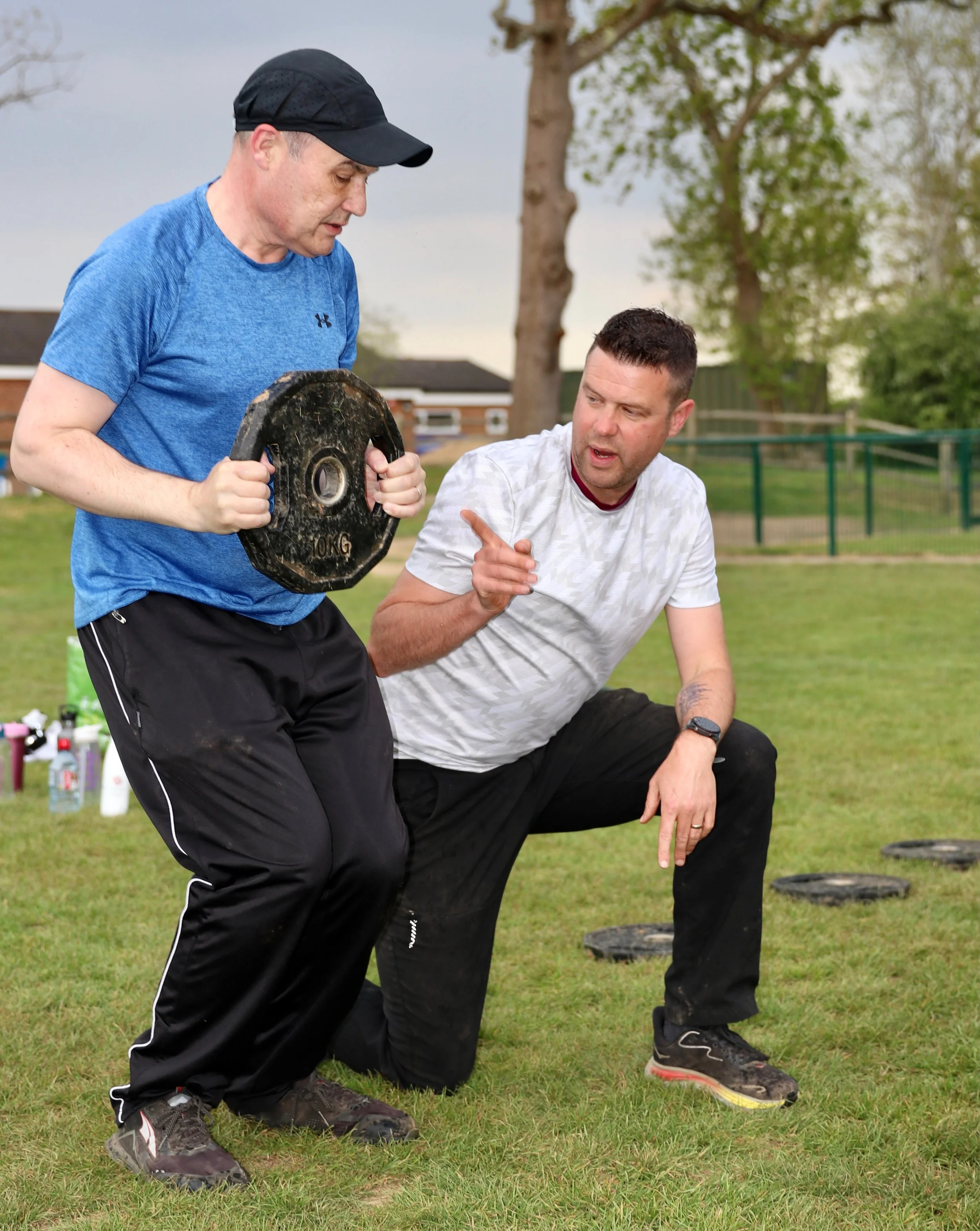 Personal trainer working with client.