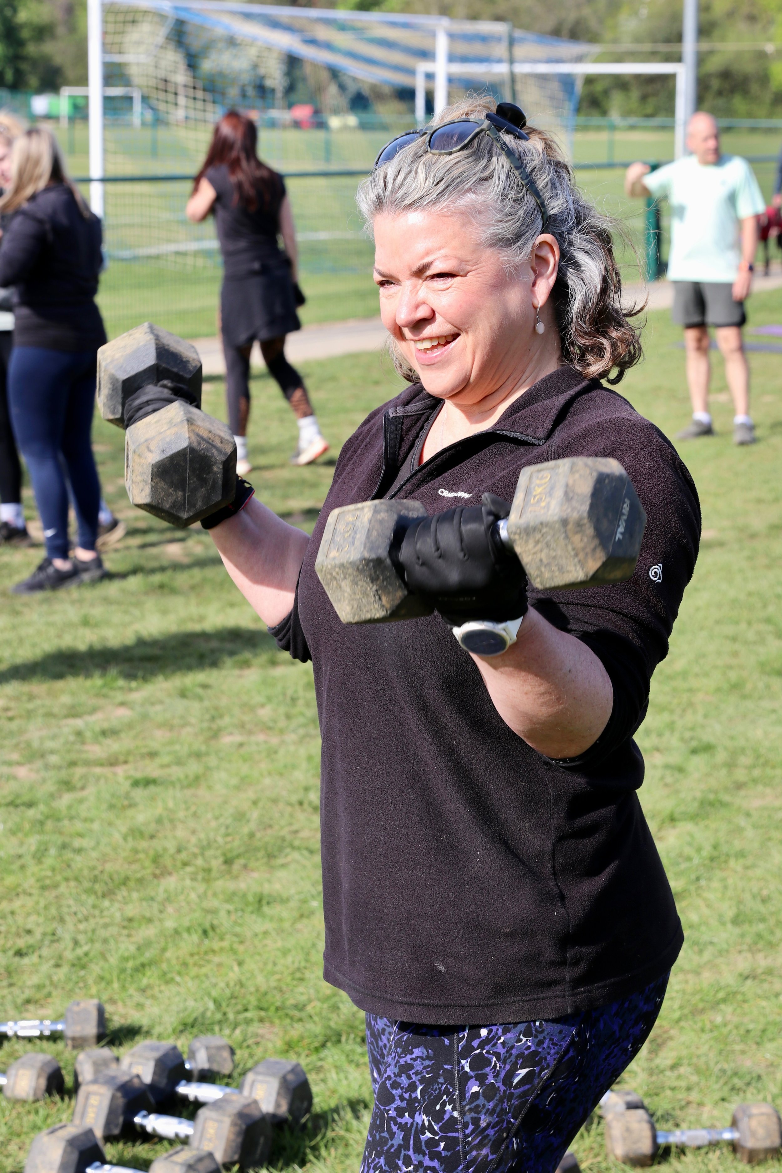 Happy female exercising with weights.