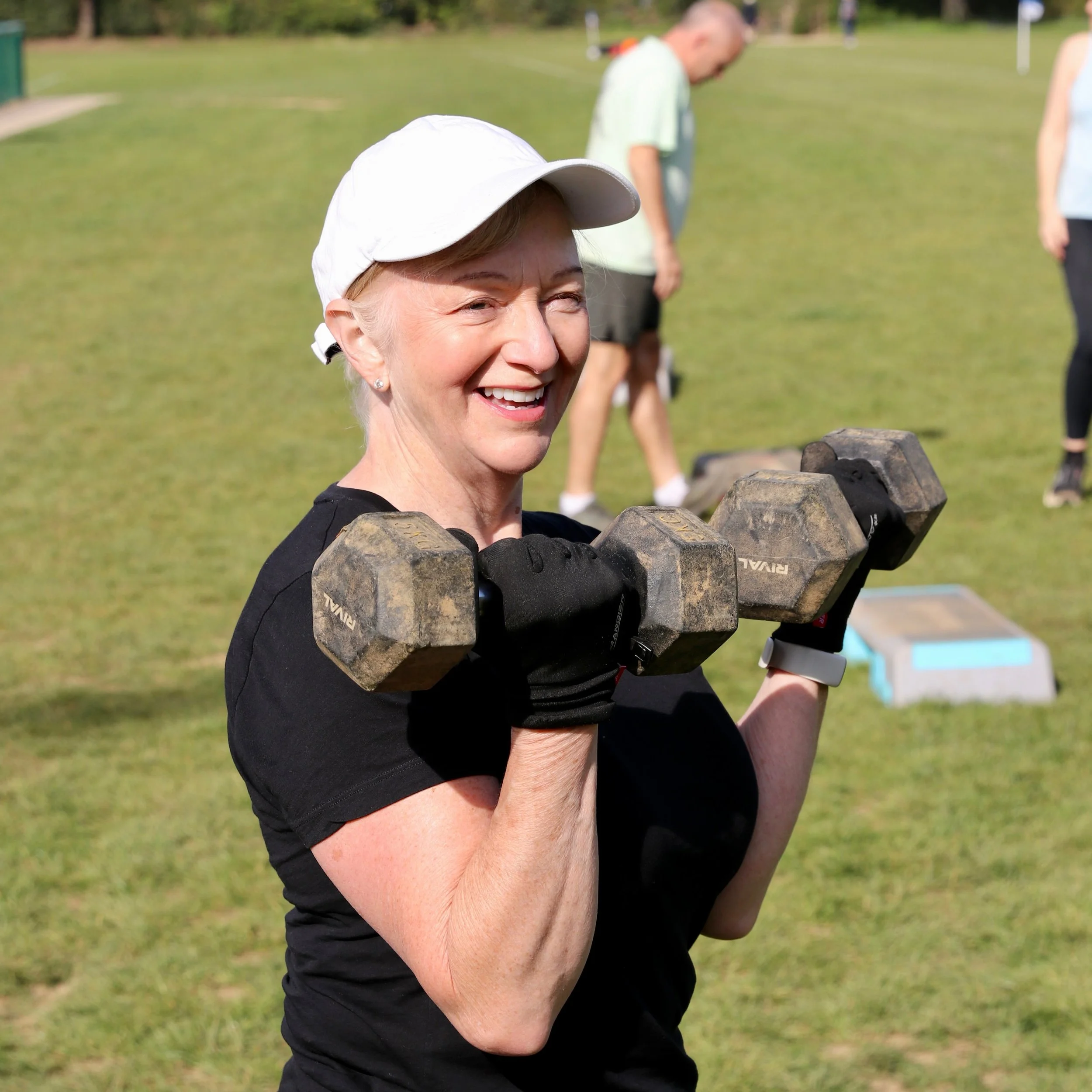 Happy lady enjoying weight lifting.
