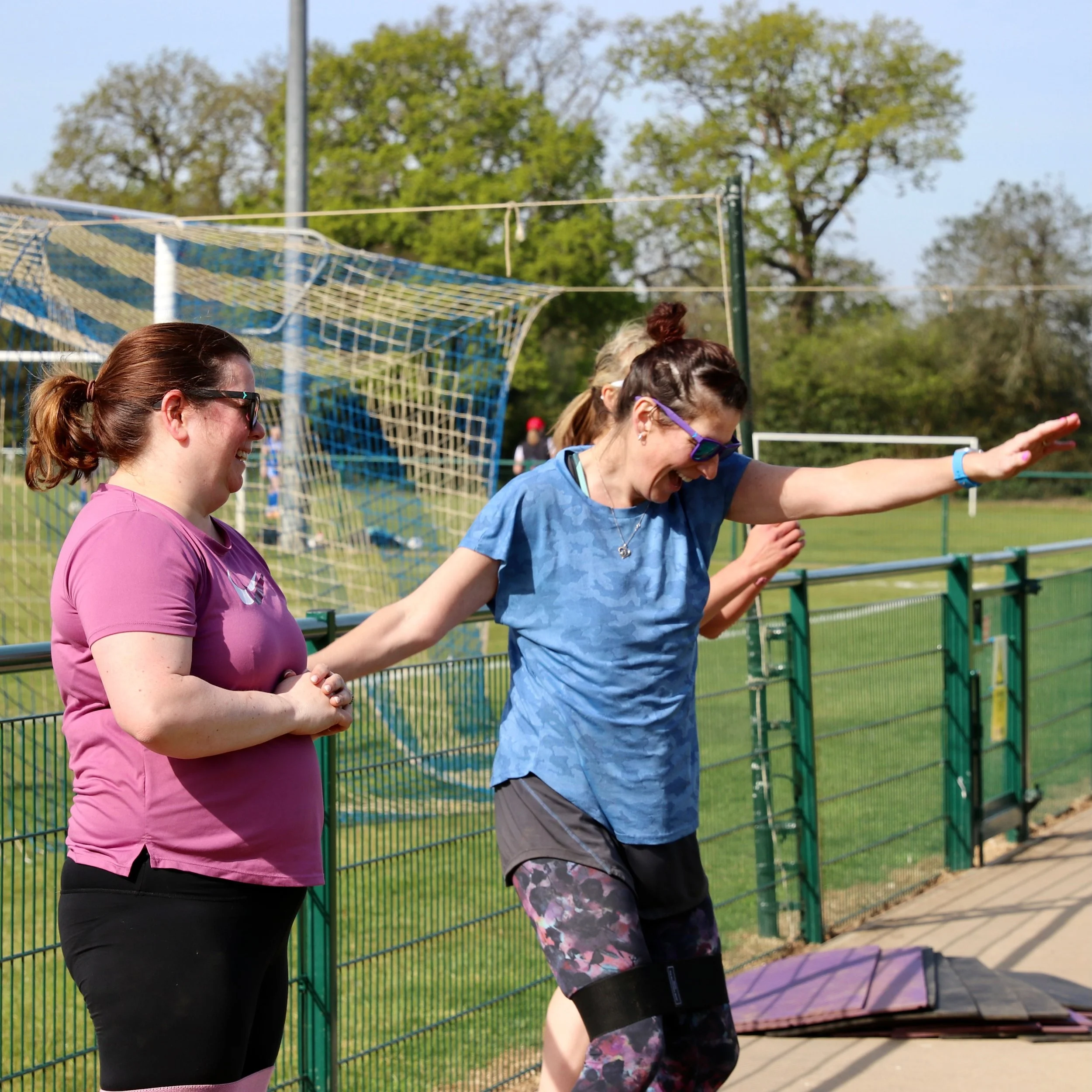 Group of ladies looking happy exercising together.