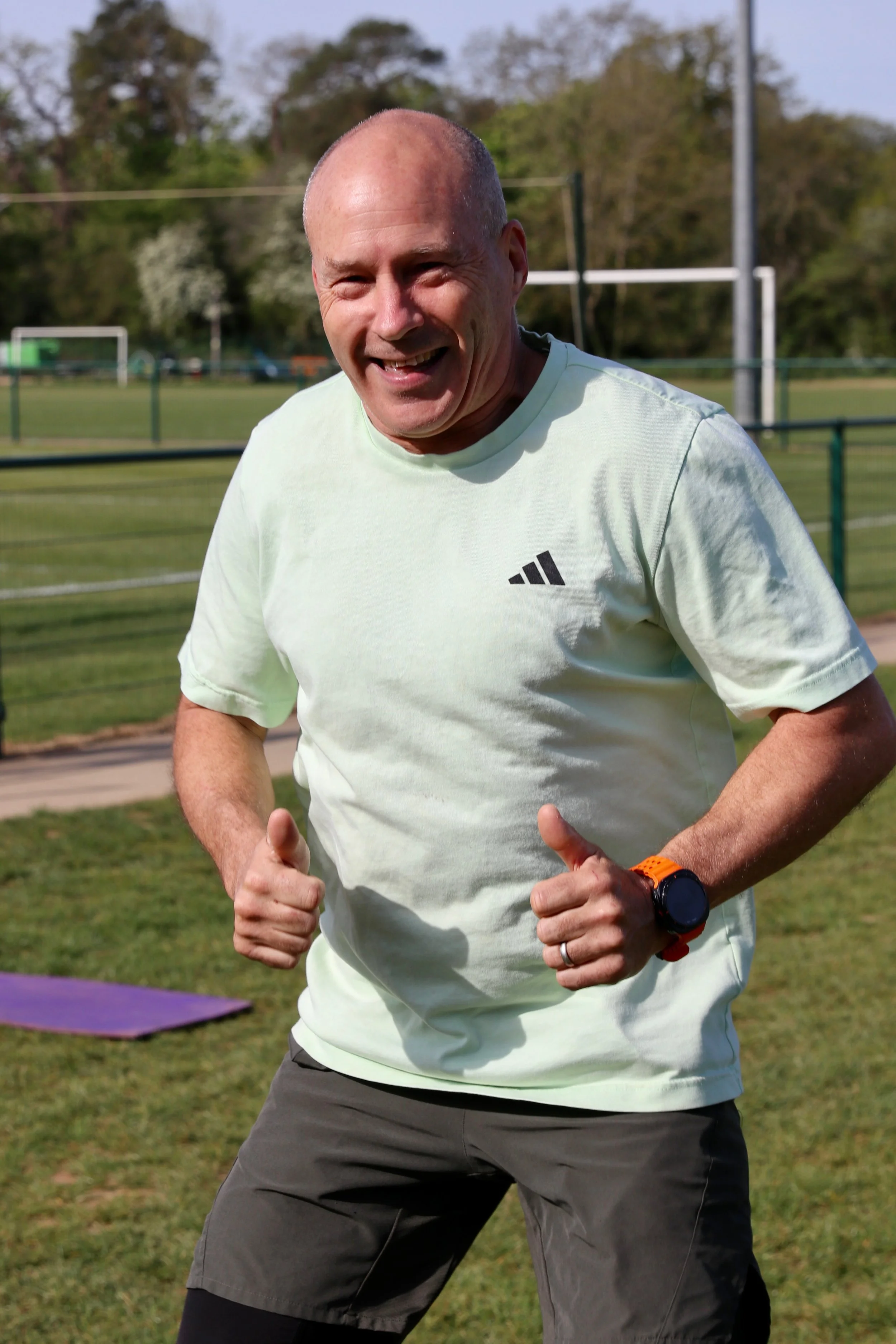 Man looking positive and happy during group exercise.