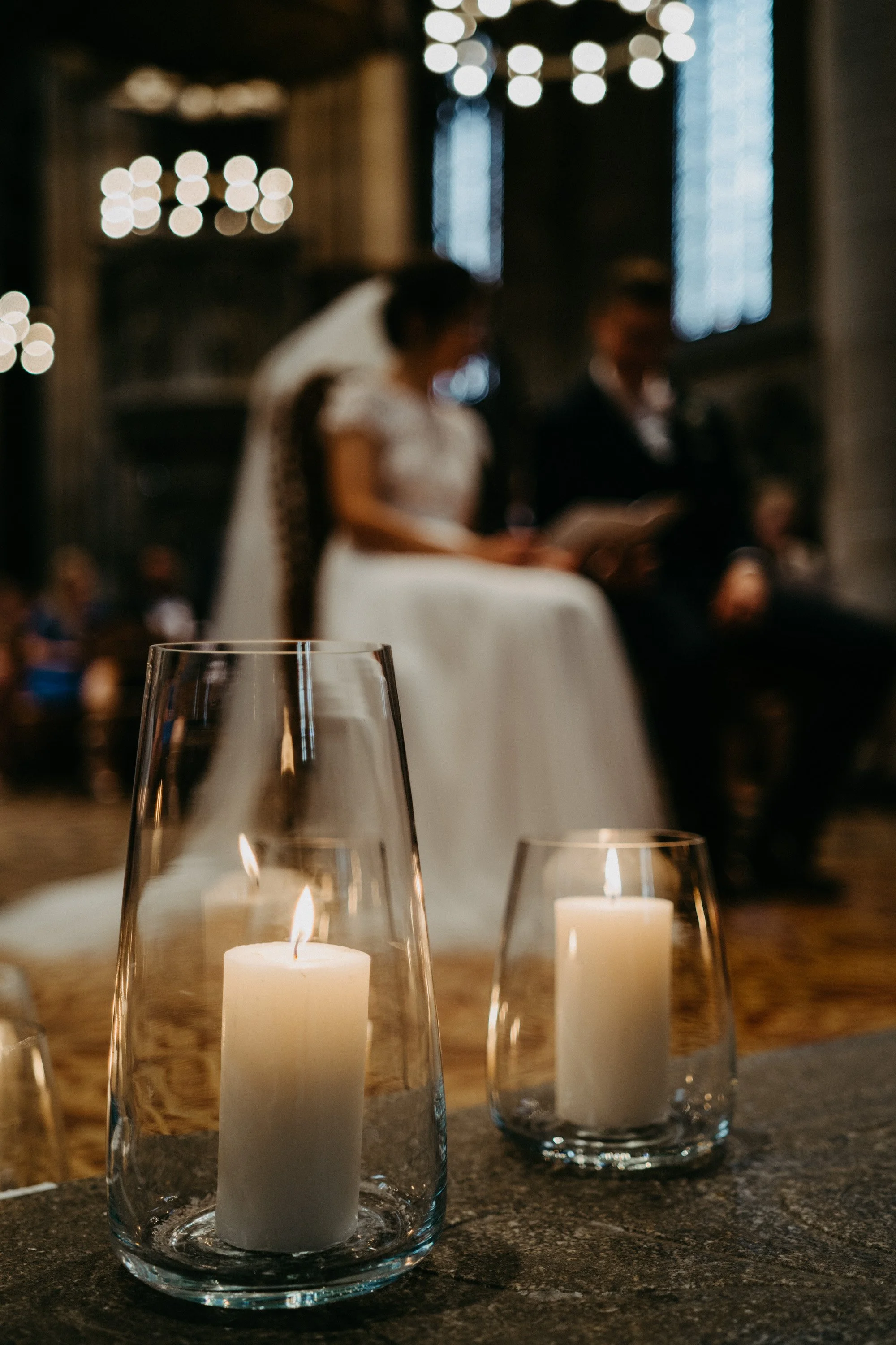 Laurie’s customers, Mariana and Carmen holding hands on a green lawn on their wedding day.