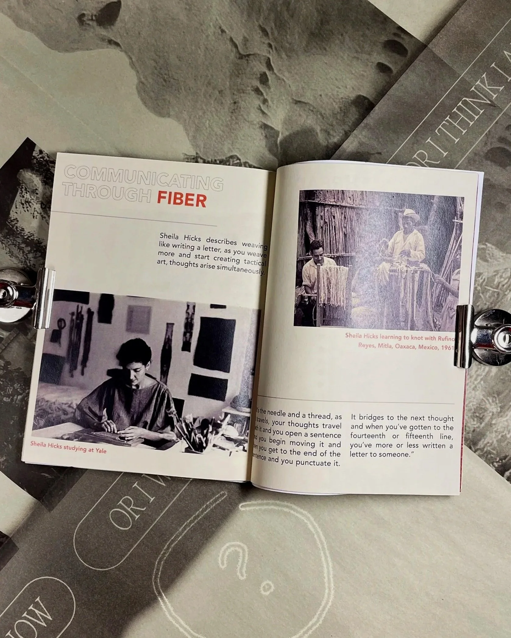 Open book showing a black and white photograph of people weaving and a section of text titled 'Communicating through fiber'.