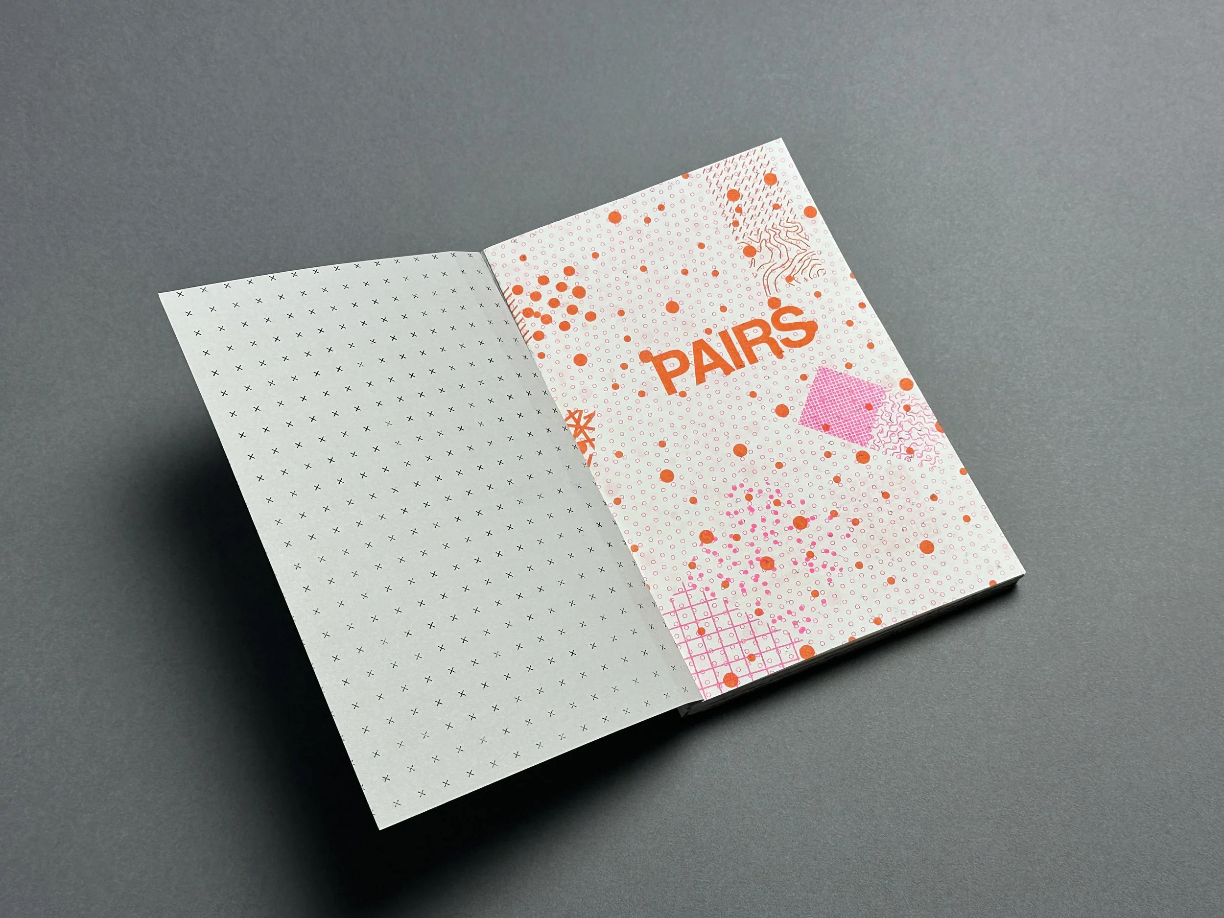 Colorful packaging with the word 'PARS' in bold orange letters, decorated with various splashes and patterns of orange and pink dots on a white background, placed on a gray surface.