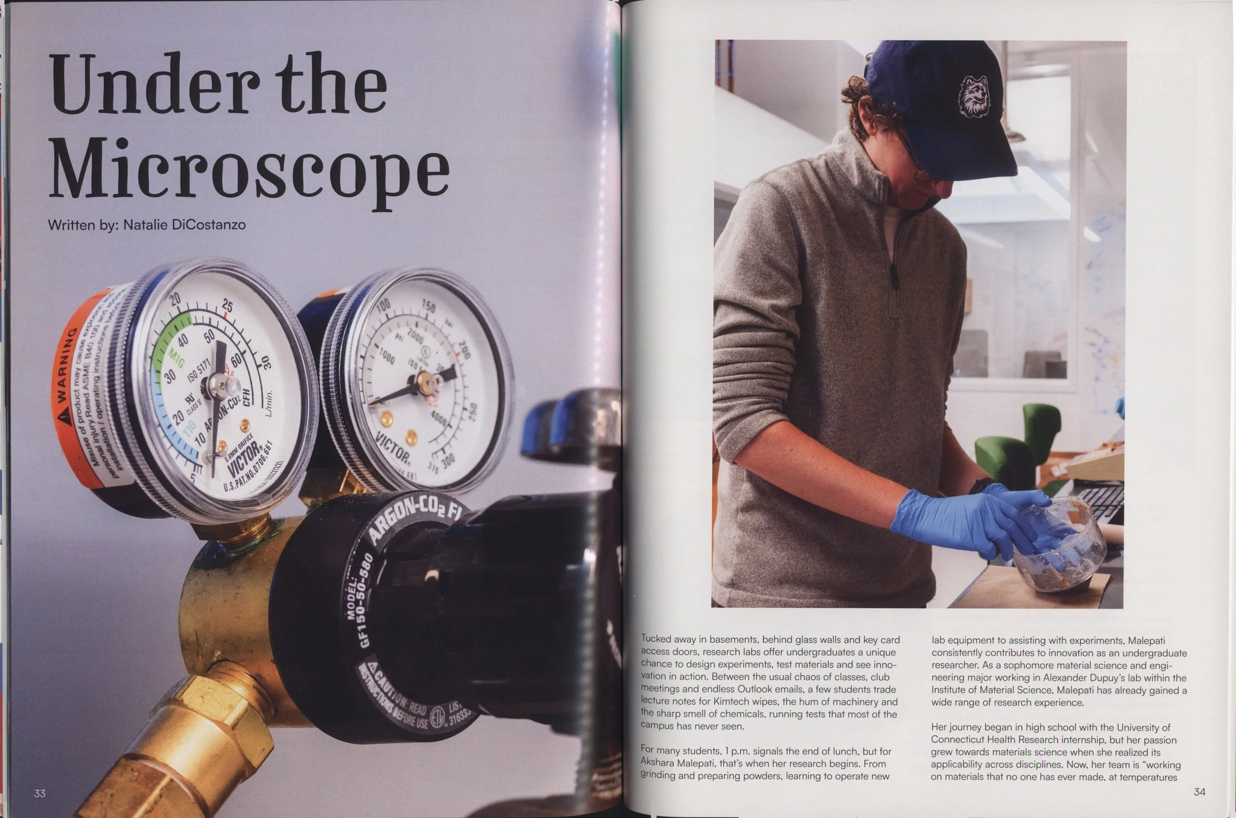 Two pressure gauges connected to a copper pipe in a laboratory setting.
