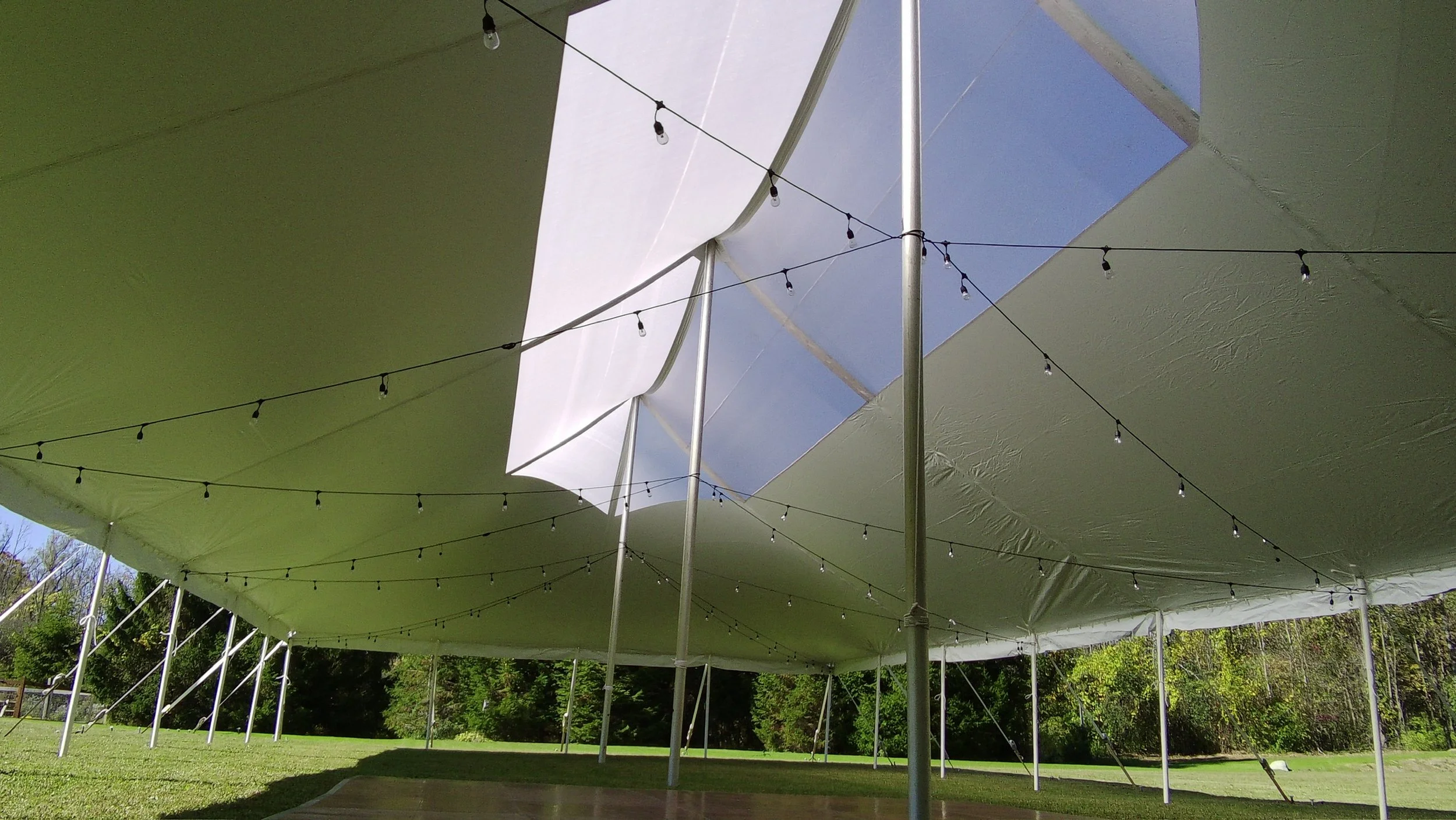 Skylight Tent setup with Edison Lights and dance floor. Setup by Whalen Tents
