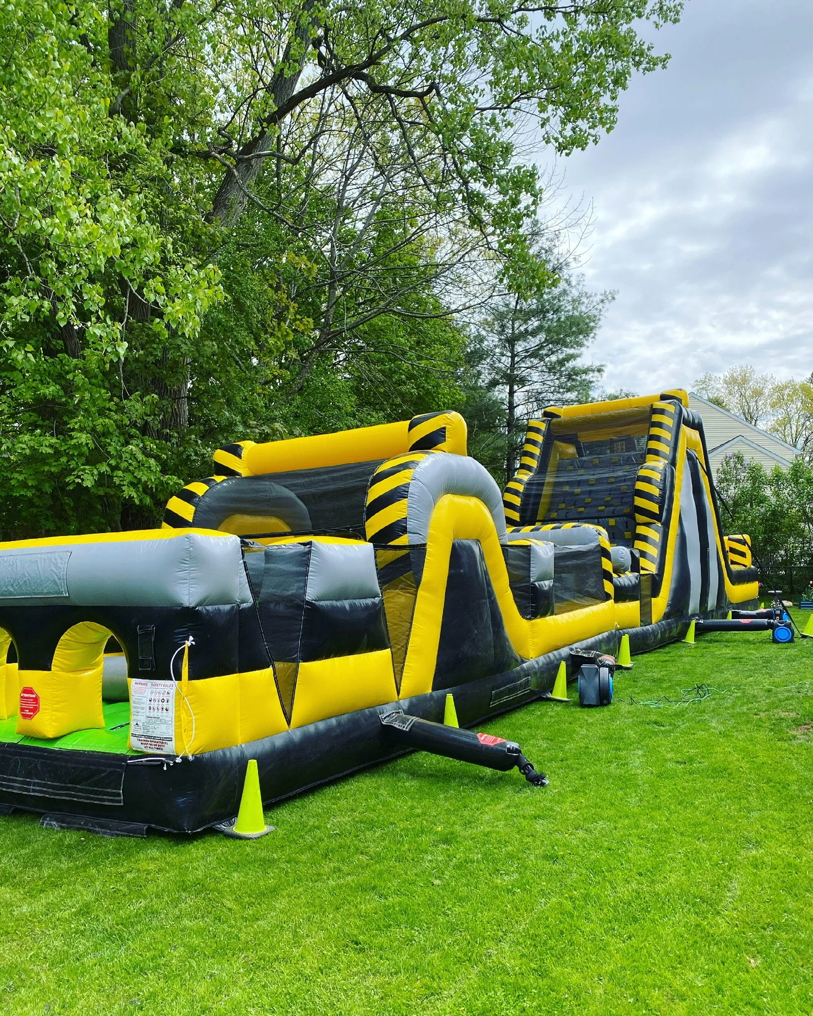 30' long obstacle course bounce house connected to 19' tall rock climb slide setup in Troy, NY setup by Whalen Tents